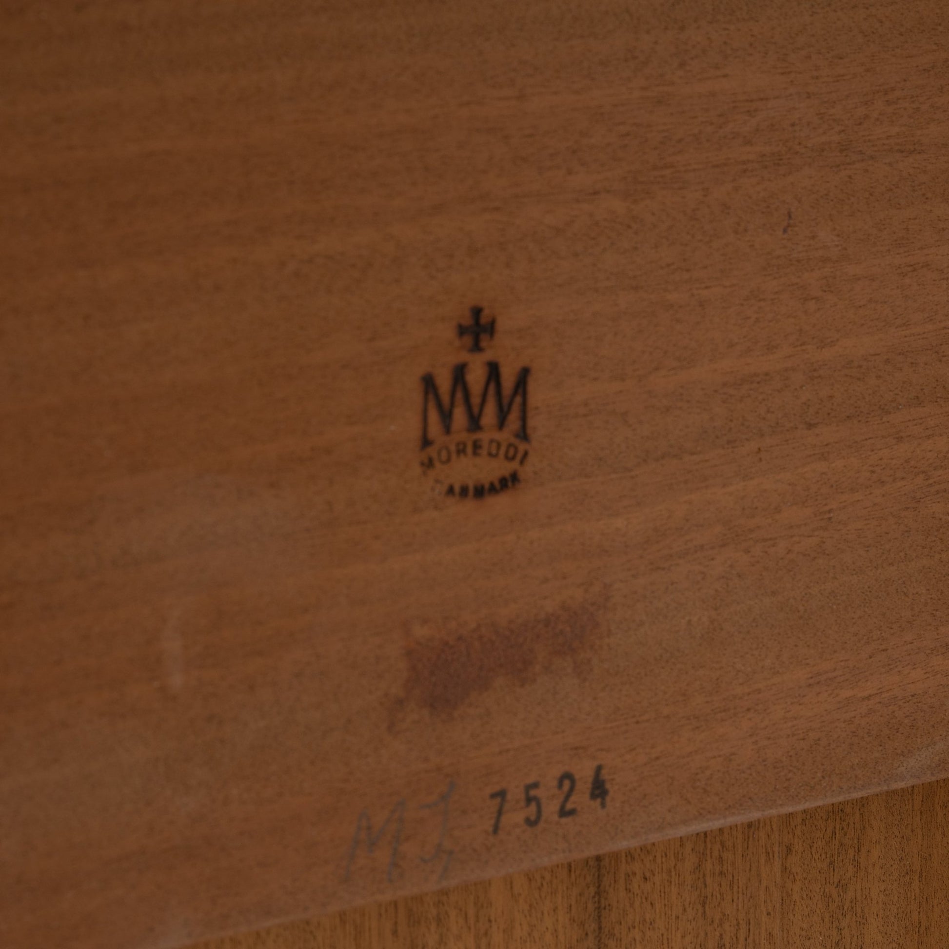 Danish Draw-Leaf Dining Table in Teak showing warm wood grain beneath the tabletop with a stamped maker mark and handwritten number