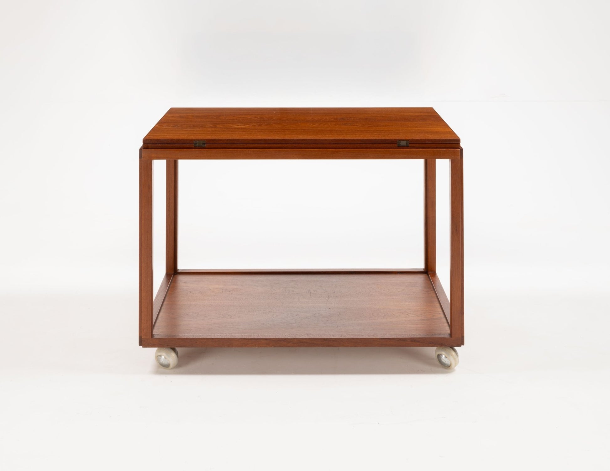 Danish teak expanding bar cart with simple rectangular design and casters on a white background