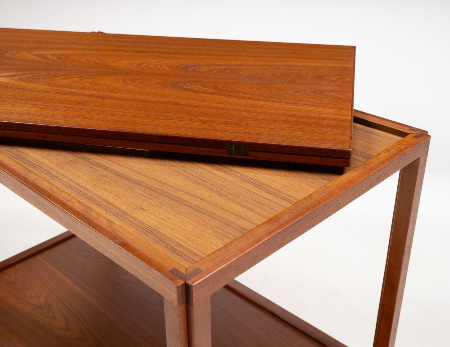 Danish teak expanding bar cart with hinged top panel and minimalist mid-century modern design from Denmark.