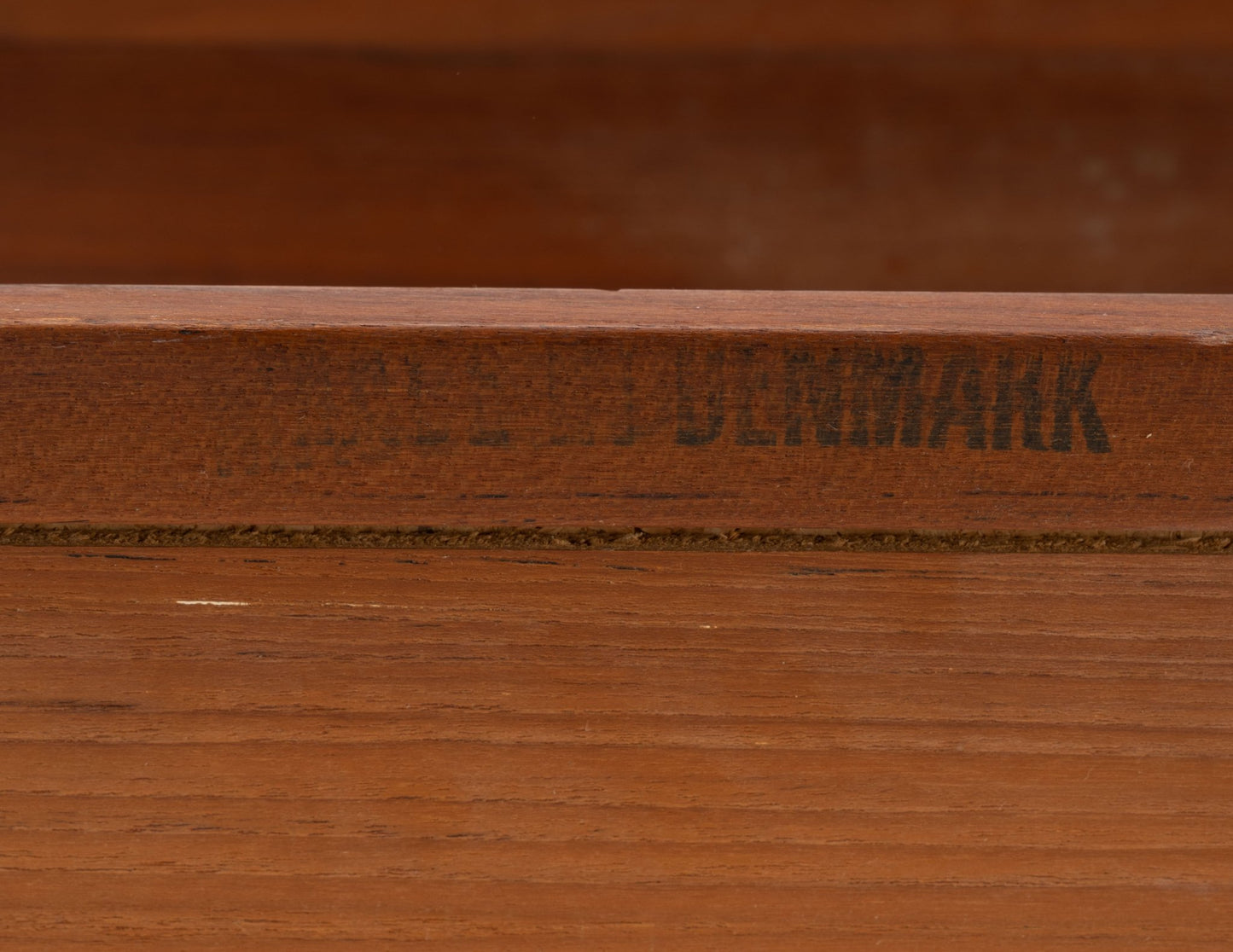 Close-up of Danish teak expanding bar cart with visible Denmark maker's mark on wood frame edge