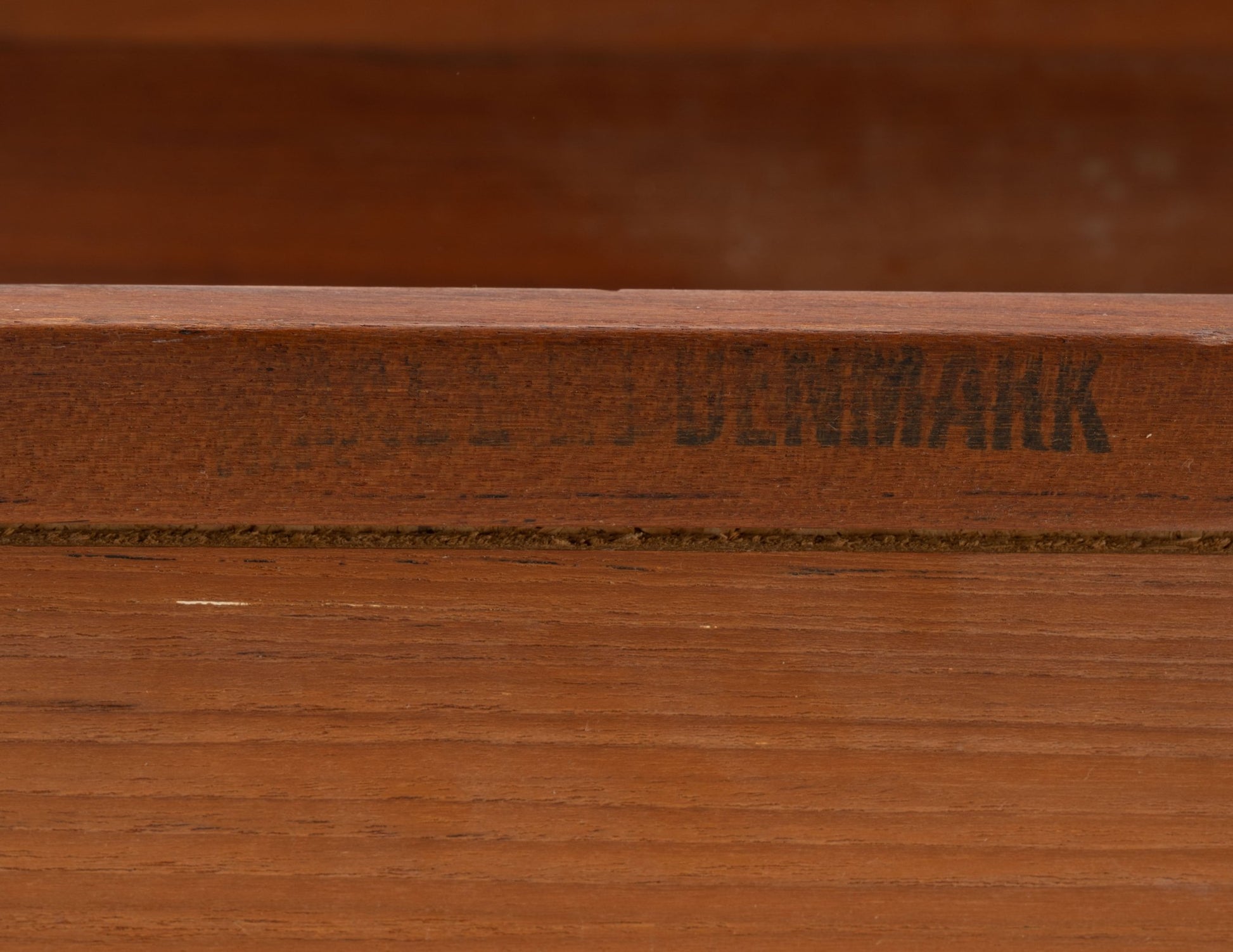 Close-up of Danish teak expanding bar cart with visible Denmark maker's mark on wood frame edge