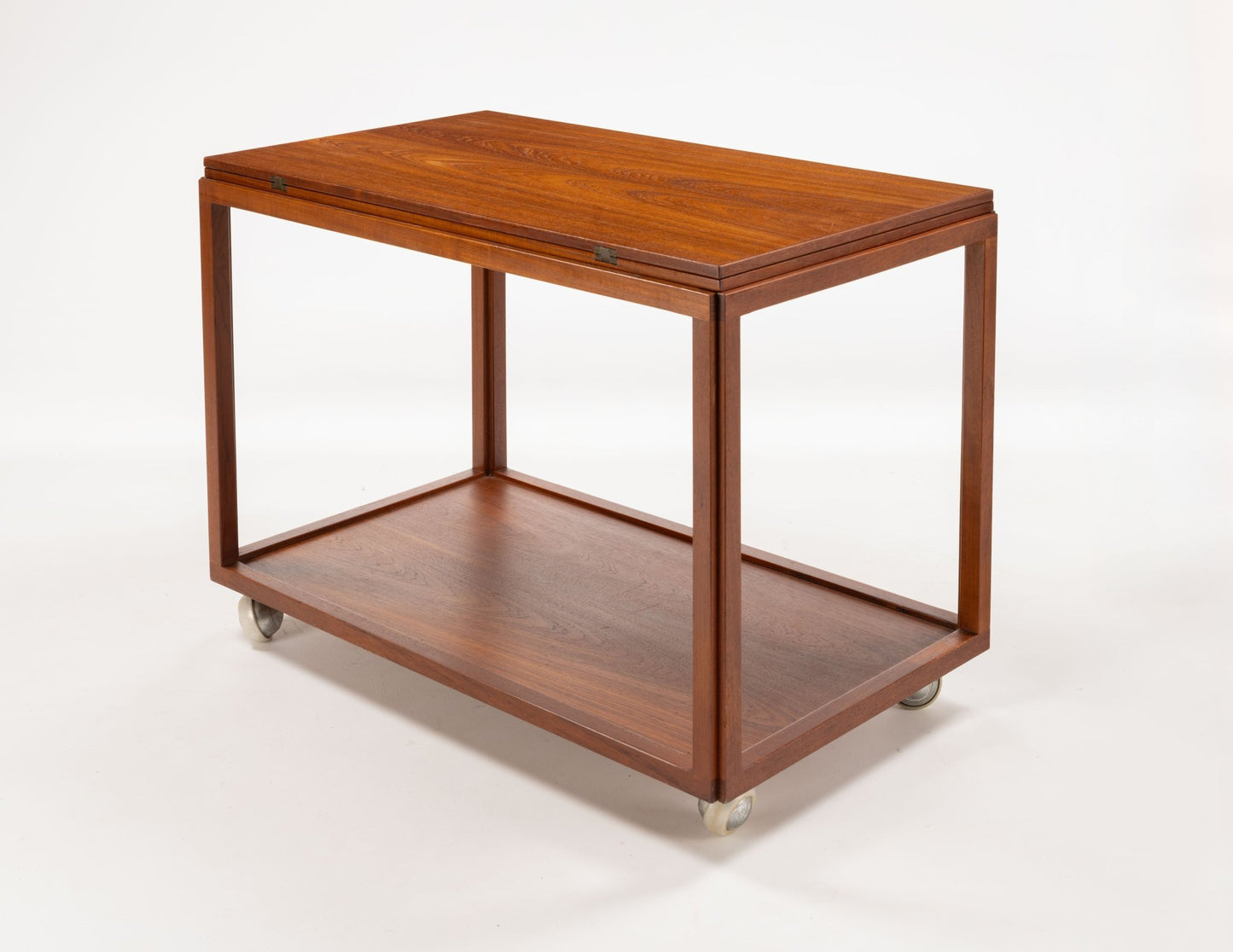 Danish teak expanding bar cart with clean lines and caster wheels, designed for versatile entertaining and serving.
