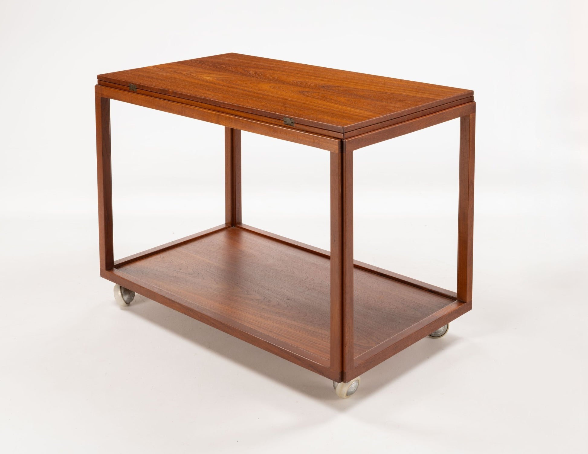 Danish teak expanding bar cart with clean lines and caster wheels, designed for versatile entertaining and serving.