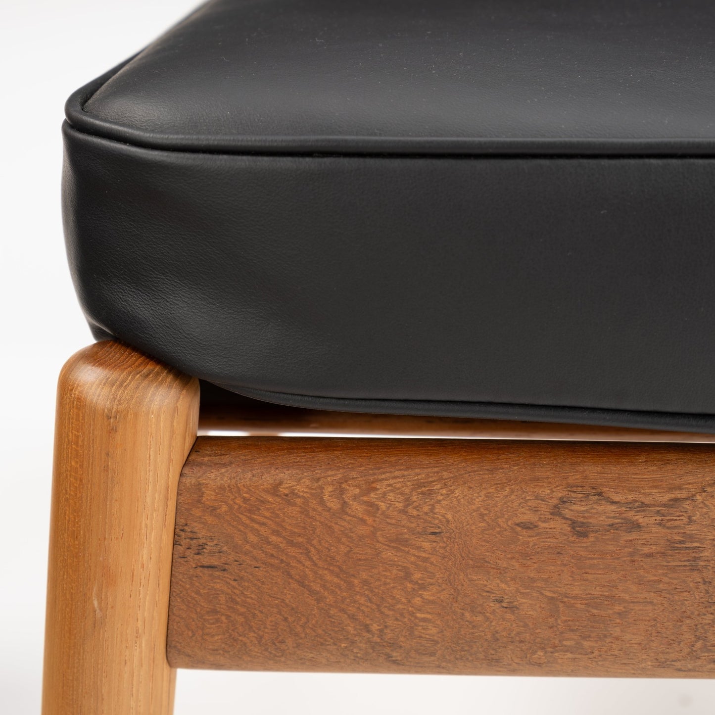 Danish Teak Ottoman with Black Leather featuring a finely crafted teak frame with rounded legs supporting a smooth black leather cushion, highlighting elegant mid century modern seating design.