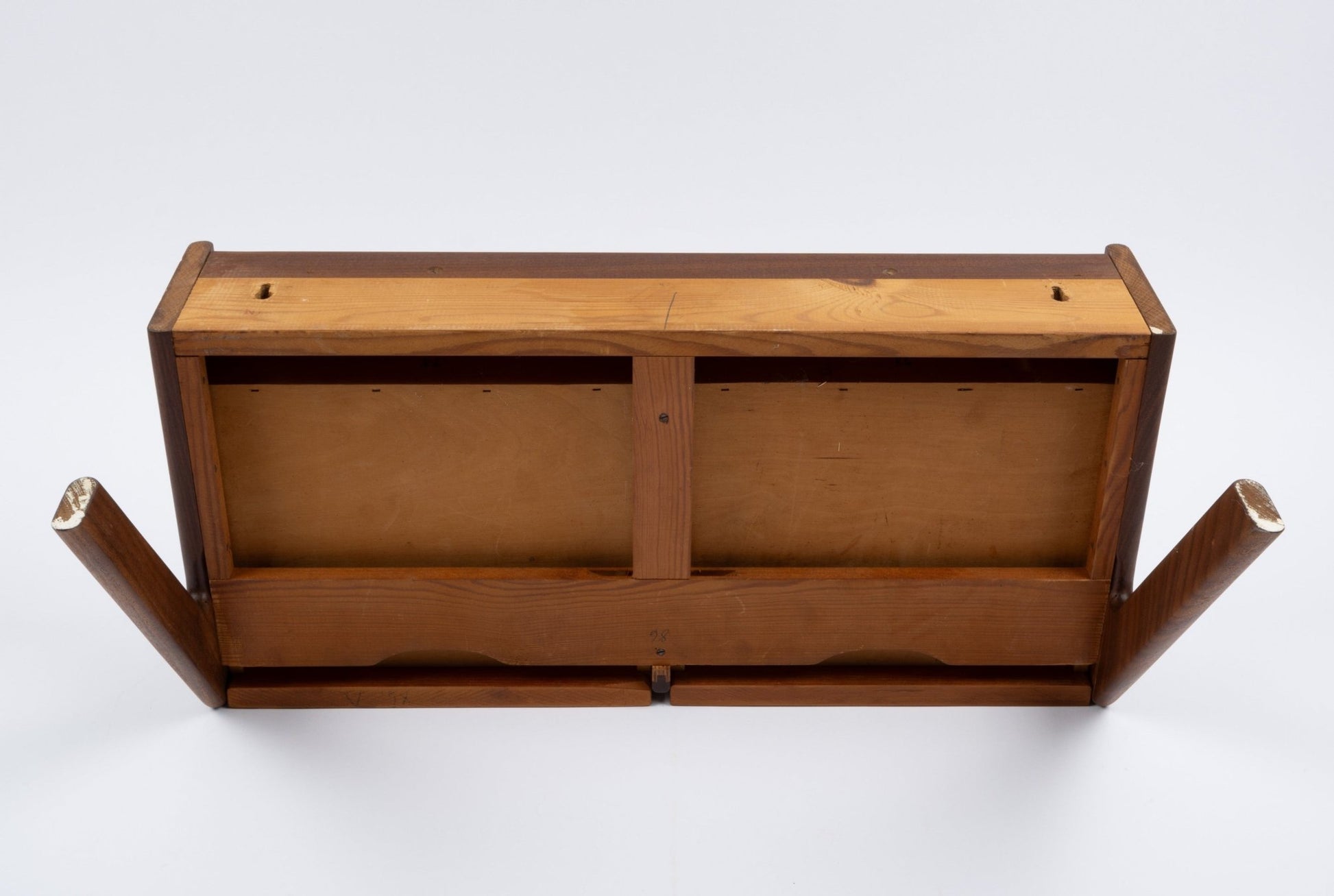 Danish modern teak wall shelf with drawer, viewed from below showing wood construction and mounting points.