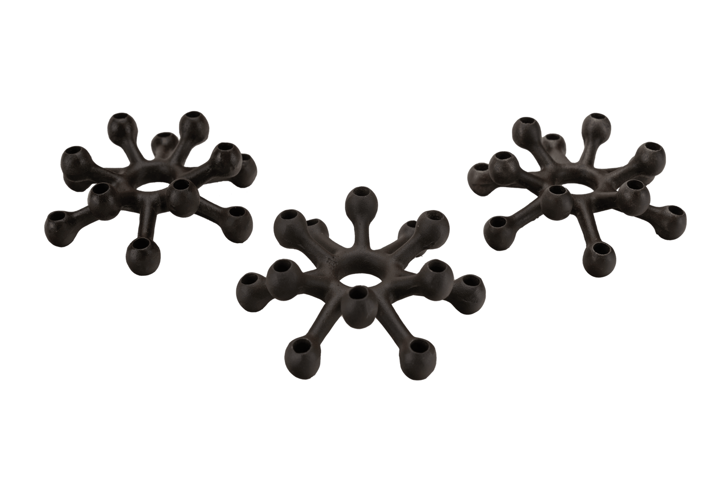 Set of three Jens Quistgaard Dansk cast iron spider candleholders with two-tiered arms for taper candles