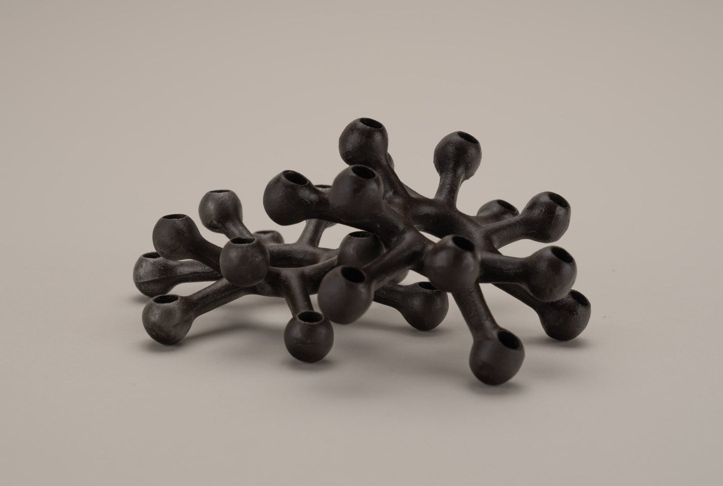 Pair of Dansk cast iron Spider candleholders designed by Jens Quistgaard with multi-tiered candle sockets in black cast iron