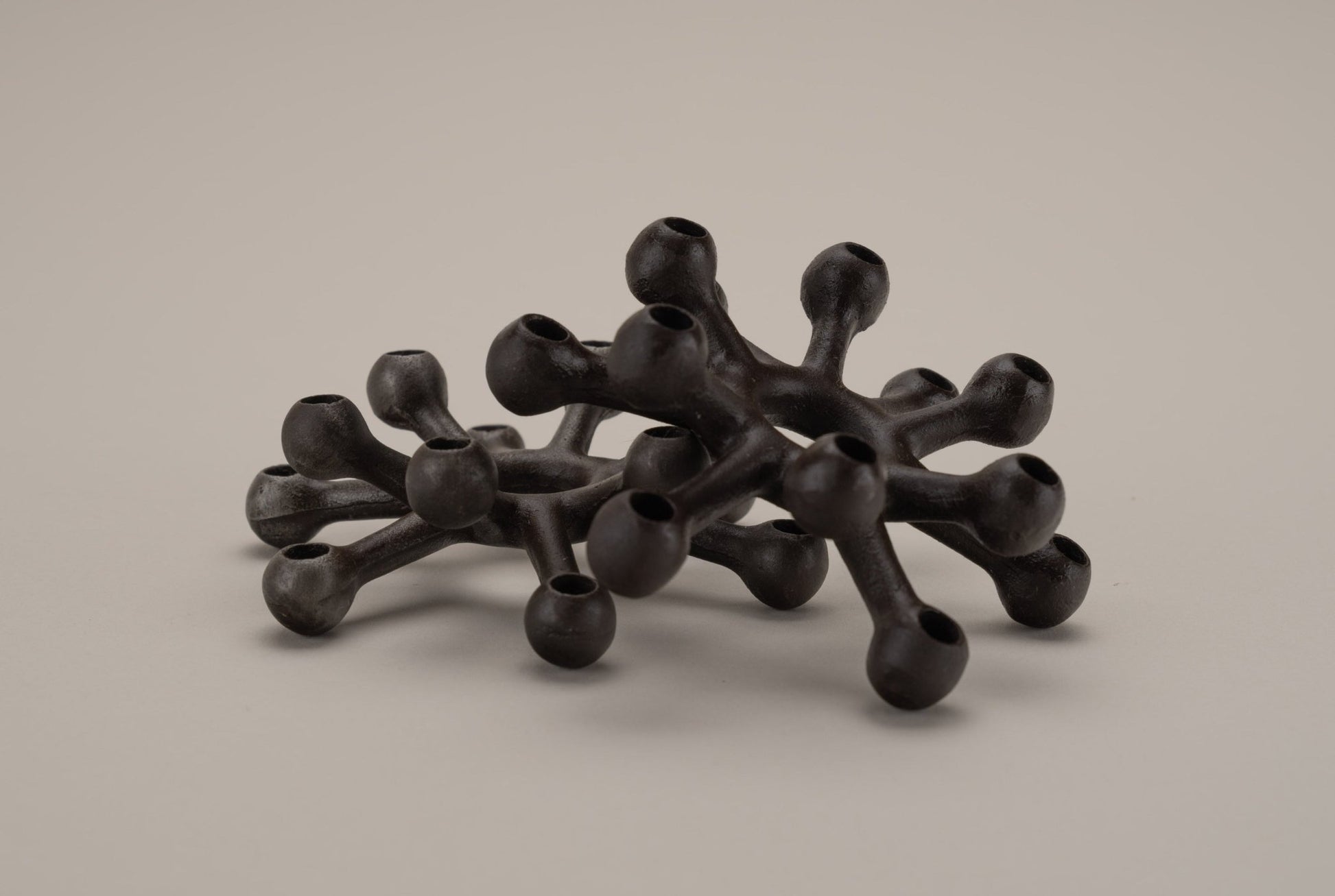 Pair of Dansk cast iron Spider candleholders designed by Jens Quistgaard with multi-tiered candle sockets in black cast iron