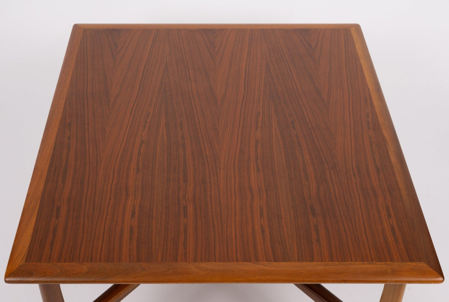 Square mid-century modern DUX coffee table with book matched teak top and framed edge on unique x-base legs.