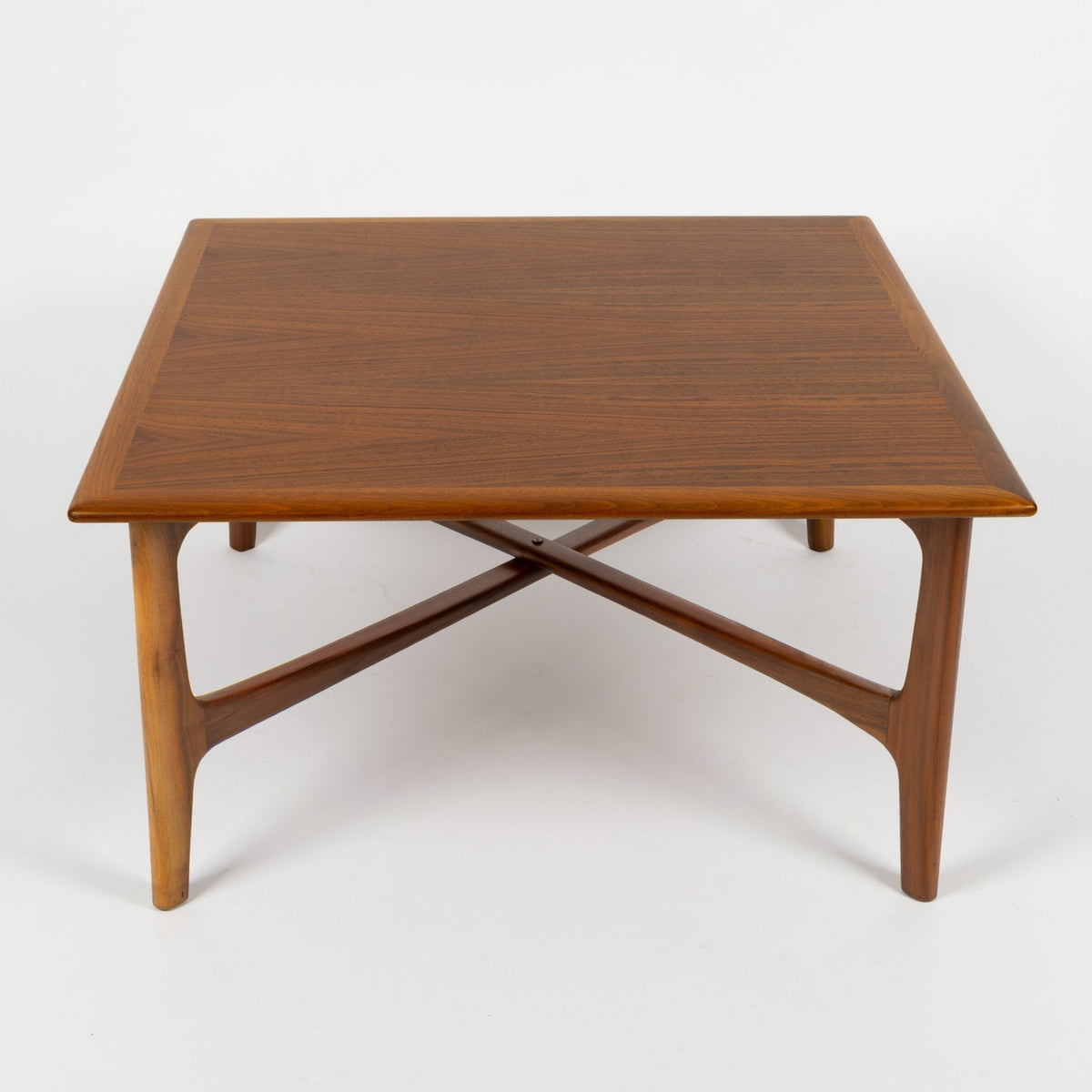DUX Square Coffee Table by Ohlsson in warm wood with square top crossed supports and tapered legs against a white background for mid century modern furniture