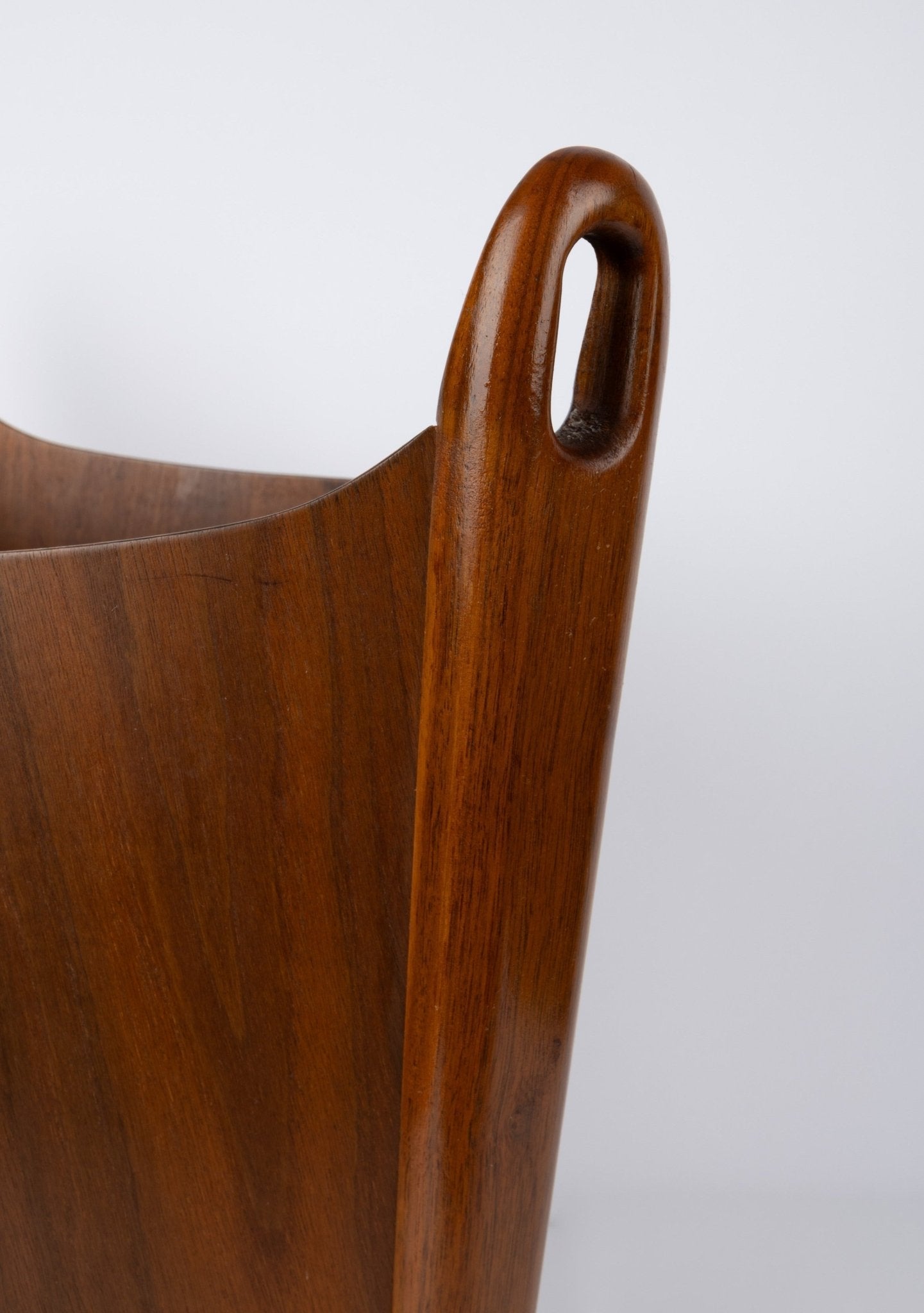 Close-up of Einar Barnes teak wastebasket handle with smooth grain and curved cutout, designed circa 1960s in Norway.