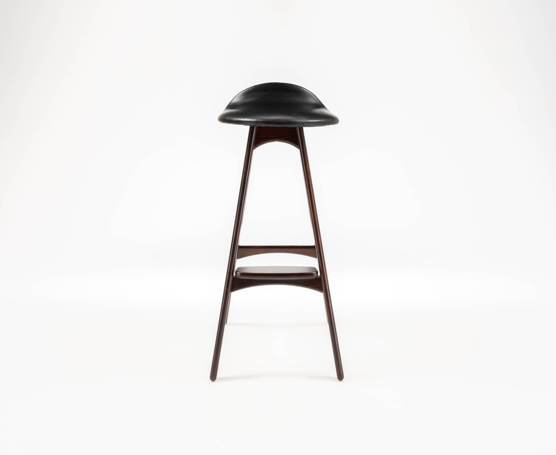 Erik Buch mid-century modern rosewood bar stool with black leather contoured seat and slim tapered legs on white background