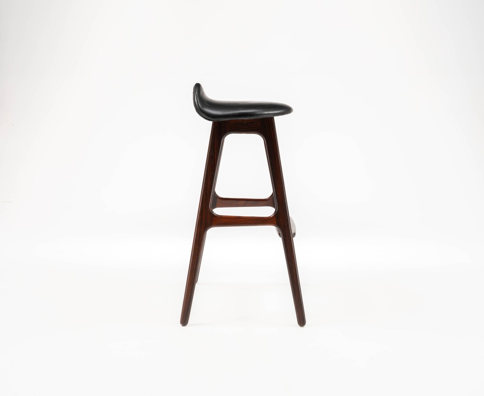 Mid-century modern Erik Buch rosewood bar stool with gently contoured black leather seat and minimalist frame.