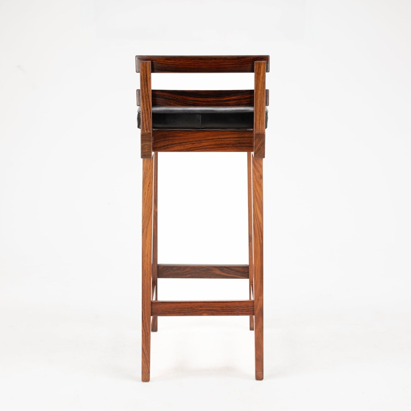 Erik Buck Pair of Rosewood Stools viewed from the back, highlighting rich rosewood grain with clean lines, horizontal backrest slats, and a black leather cushioned seat reflecting mid century modern seating design.
