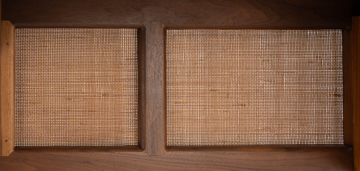 Close-up of mid-century modern Finn Juhl executive desk featuring walnut wood and woven cane panels