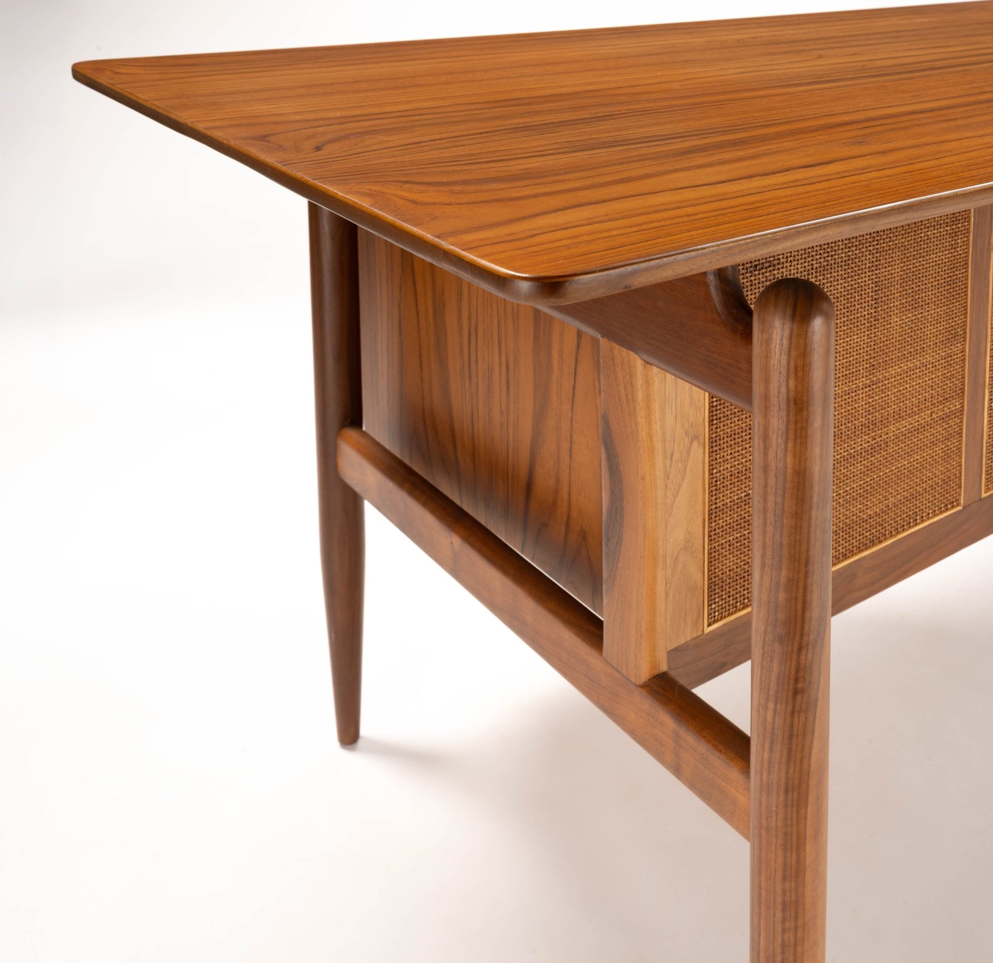 Finn Juhl mid-century modern walnut executive desk with cane panel, tapered legs, and smooth rounded edges