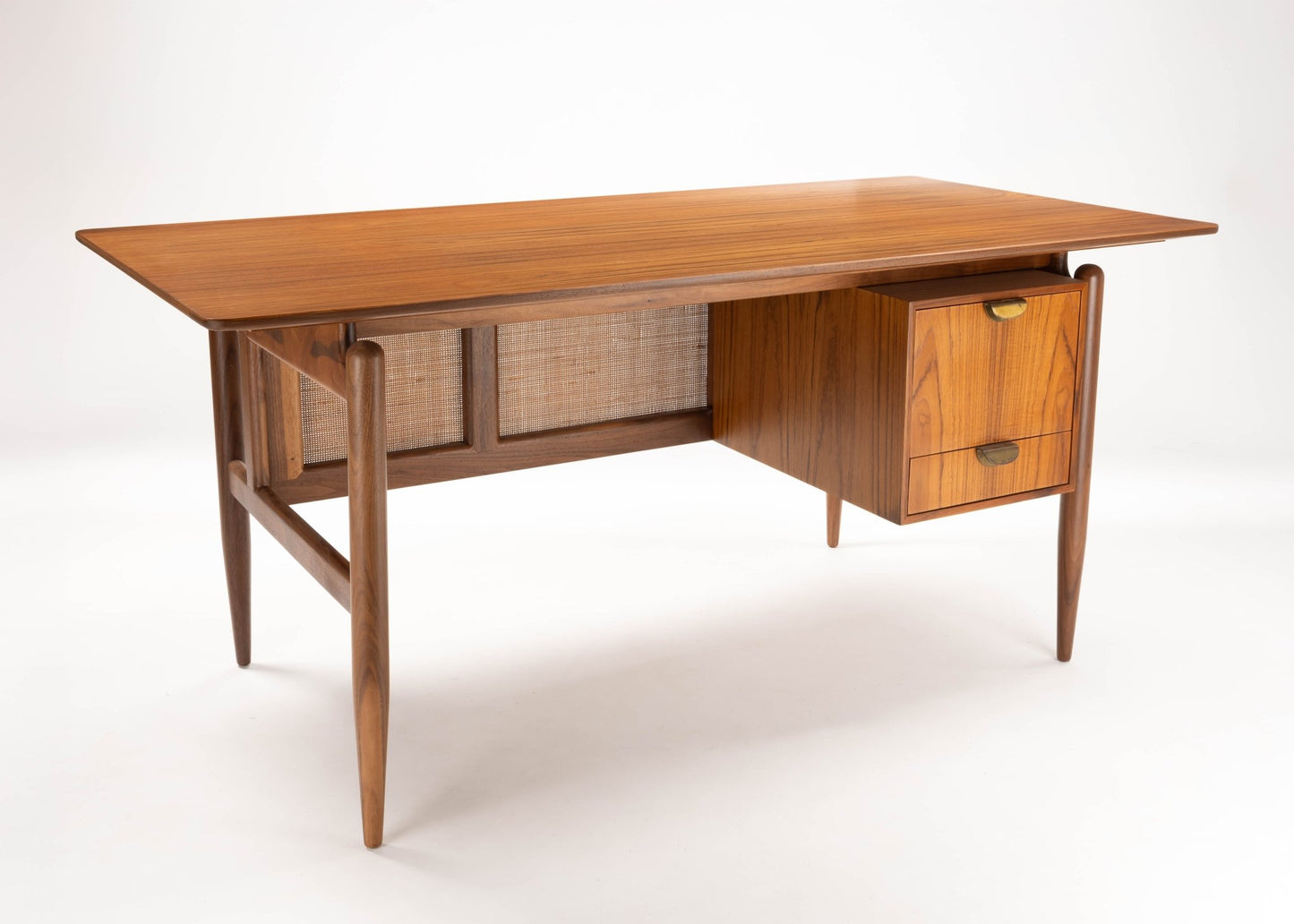 Finn Juhl Executive walnut wood desk with caning detail and two drawers, showcasing 1950s mid-century modern design.