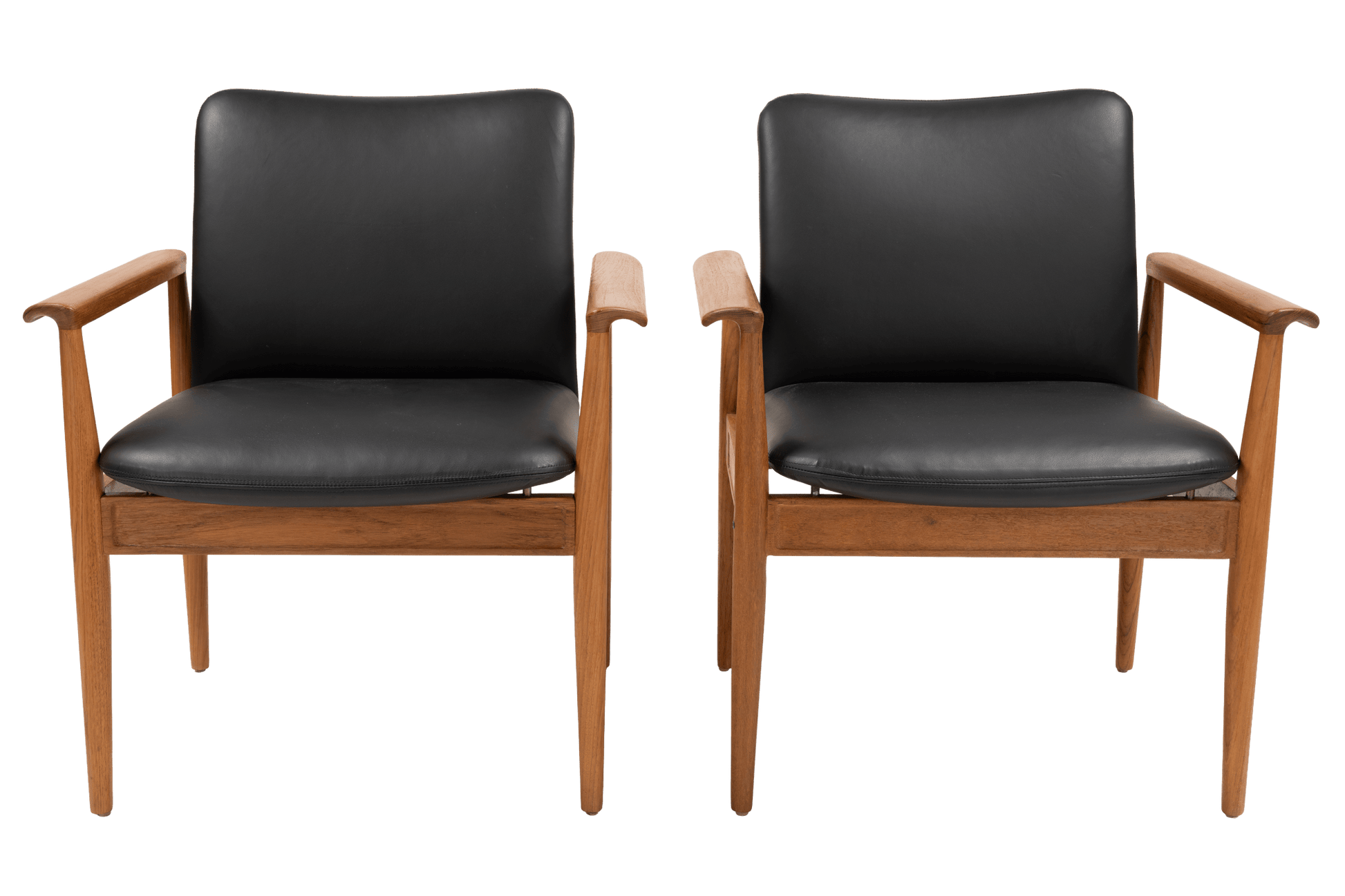 Pair of Finn Juhl Model 209 “Diplomat” chairs with teak frames and black leather cushions on tapered legs