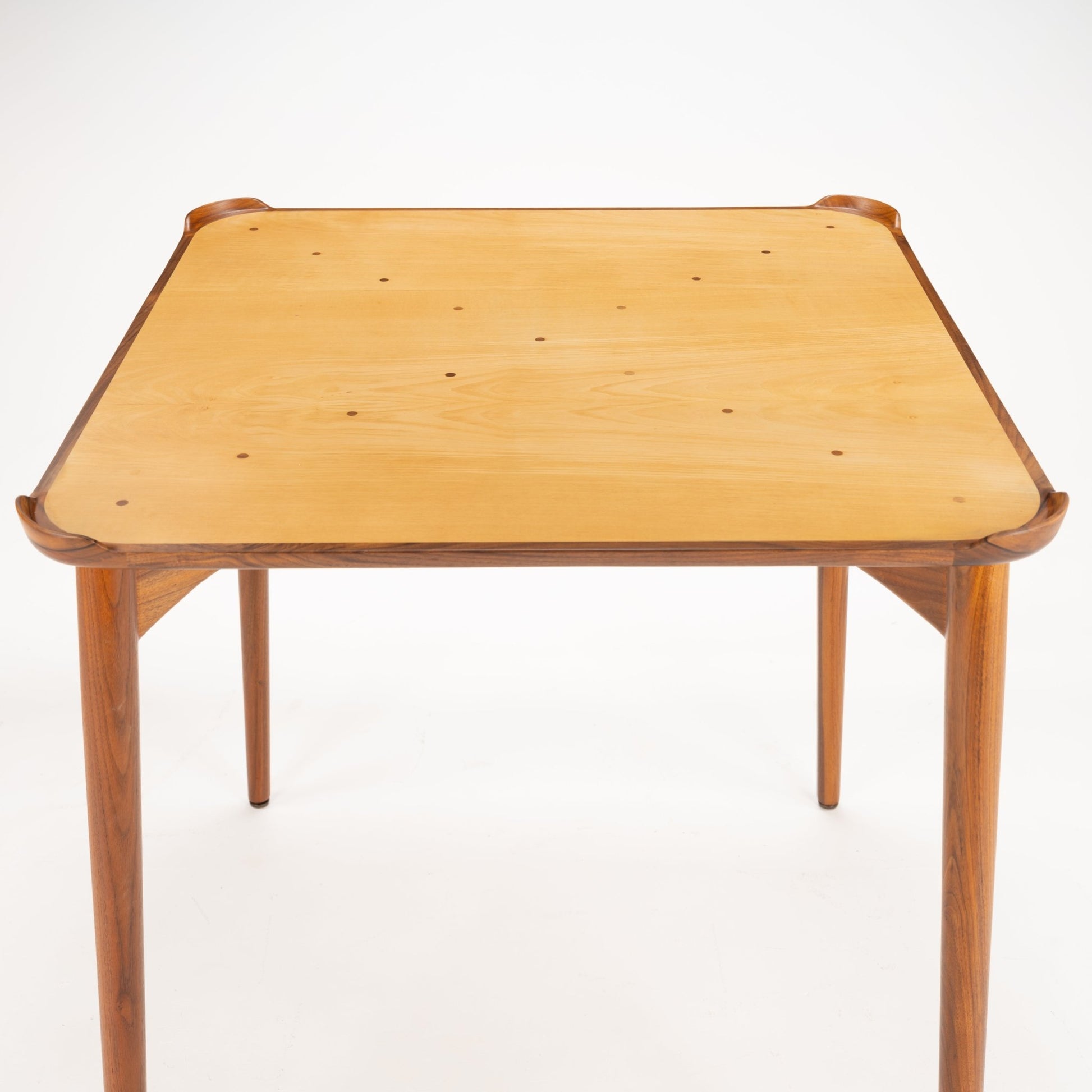 Finn Juhl Walnut Card Table for Baker highlighting a smooth, natural wood tabletop with rounded edges and sculpted walnut frame supported by slender, tapered legs, embodying vintage Danish mid century modern design.