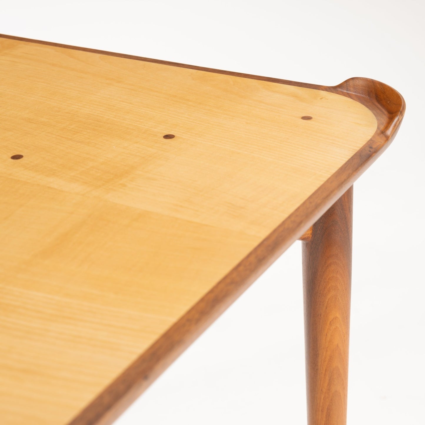 Finn Juhl Walnut Card Table for Baker featuring a light wood tabletop with rounded corners and subtle wood grain, framed by sculpted walnut edges and supported by slender, tapered walnut legs in vintage Danish mid century modern style.