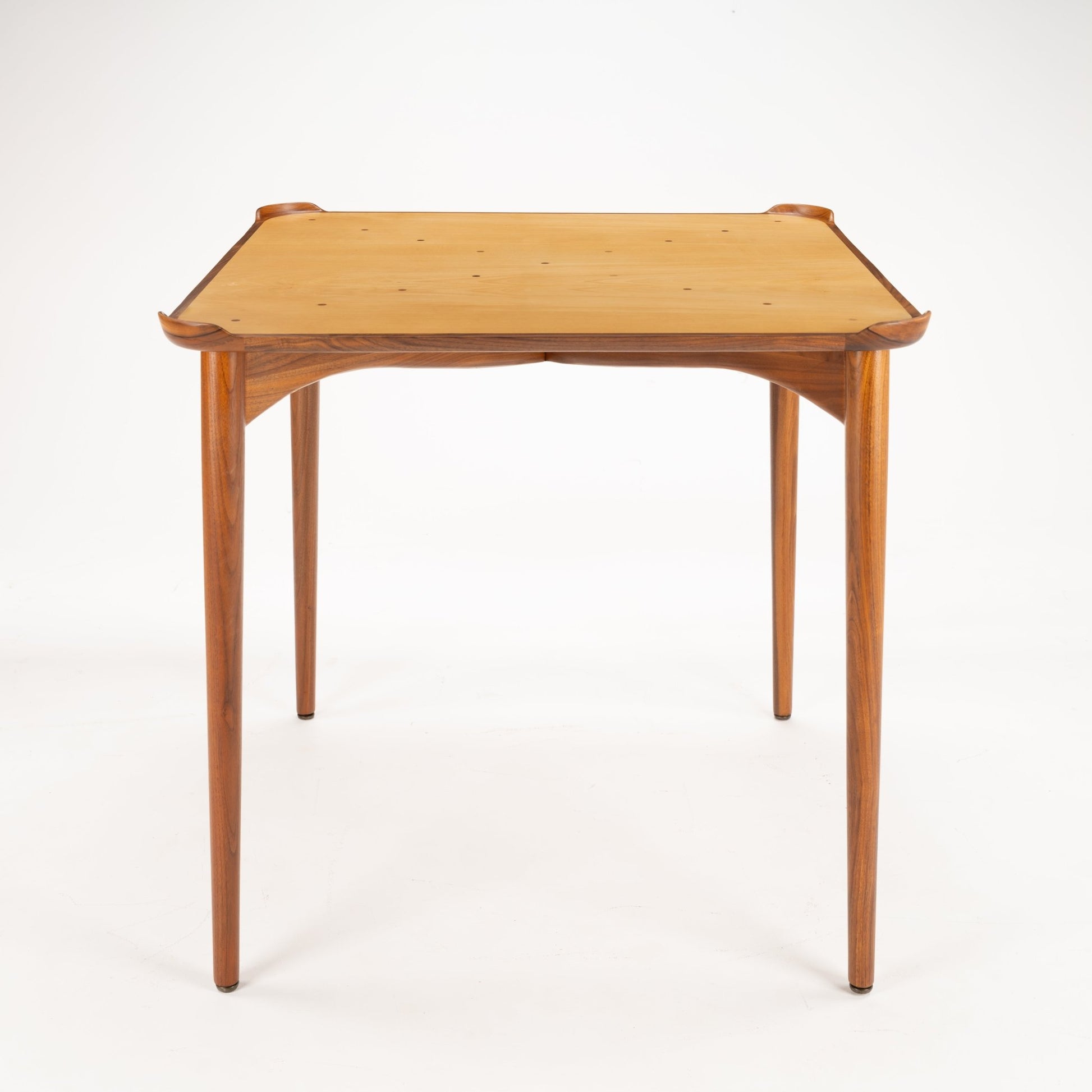 Finn Juhl Walnut Card Table for Baker showcasing a refined walnut frame with tapered legs and a smooth, light wood tabletop, reflecting classic mid century modern furniture design.
