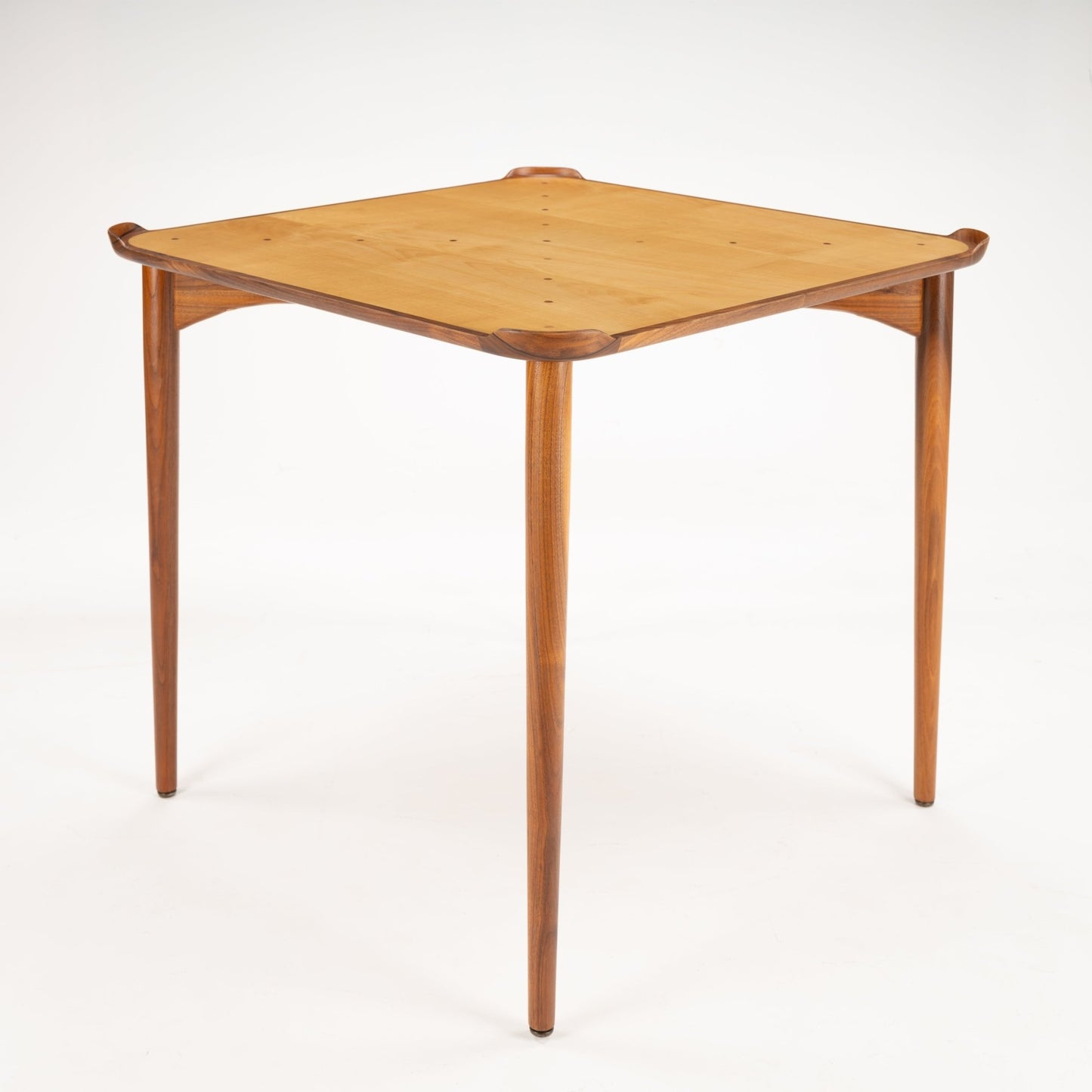 Finn Juhl Walnut Card Table for Baker featuring a light wood square top with rounded corners nestled in a sculpted walnut frame, supported by four slender, tapered legs in vintage Danish mid century modern style.