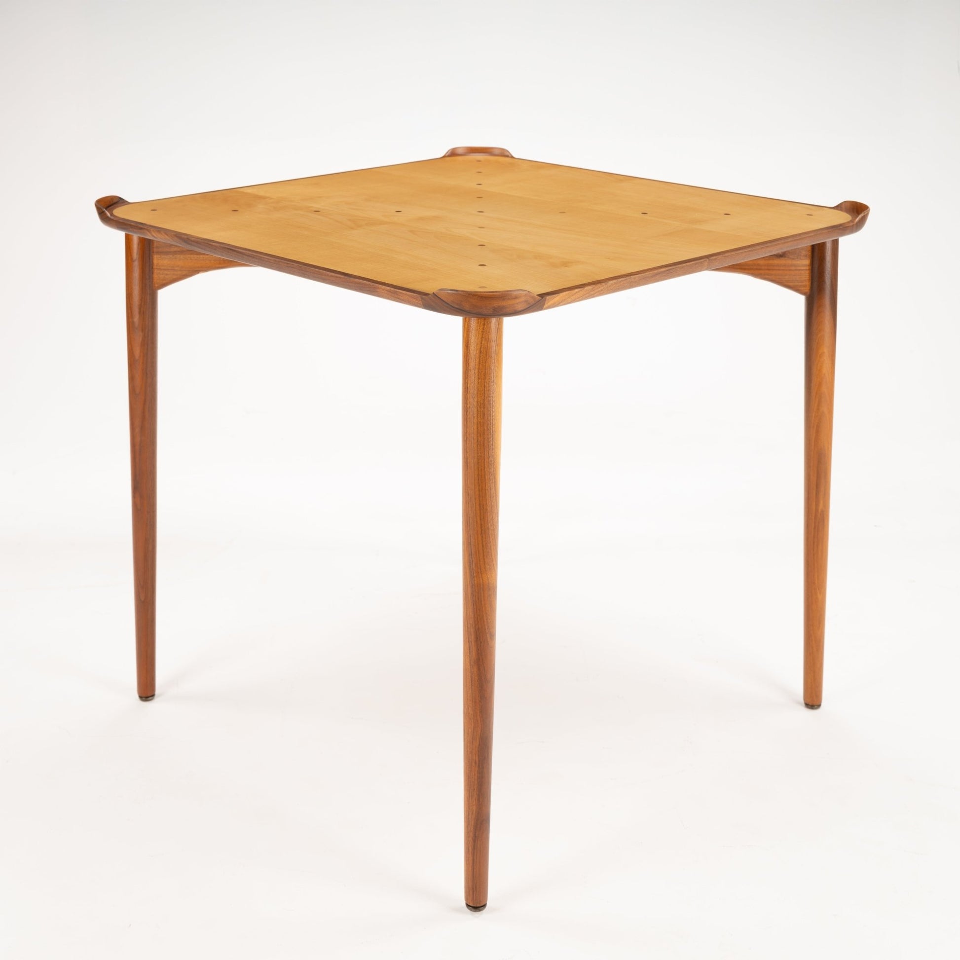 Finn Juhl Walnut Card Table for Baker featuring a light wood square top with rounded corners nestled in a sculpted walnut frame, supported by four slender, tapered legs in vintage Danish mid century modern style.