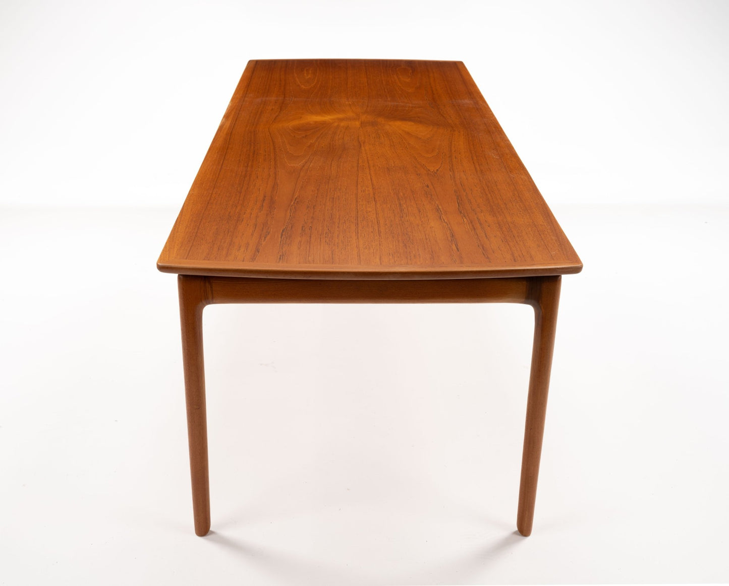 Mid-century modern teak floating top coffee table with slender tapered legs and clean minimalist design on white background