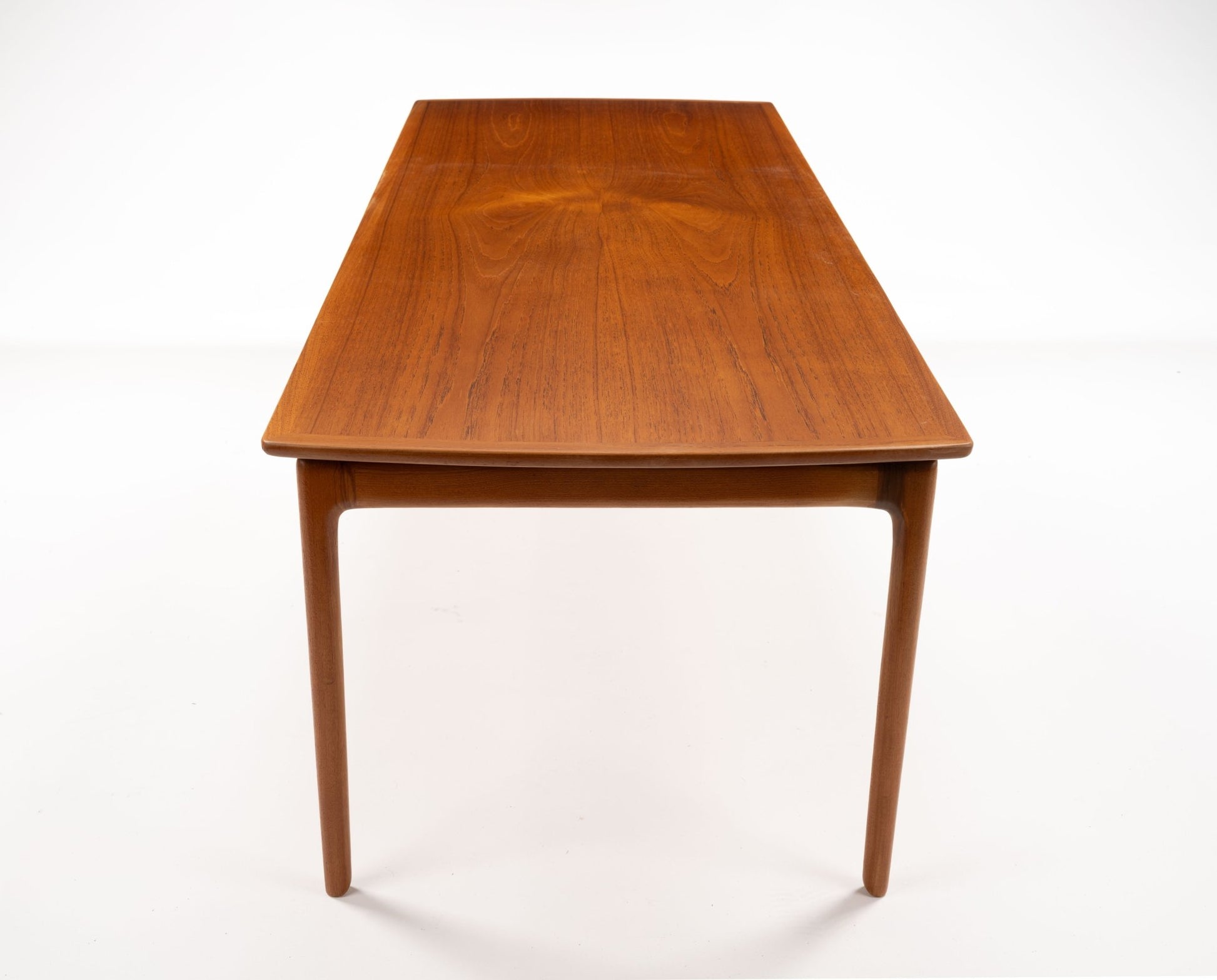 Mid-century modern teak floating top coffee table with slender tapered legs and clean minimalist design on white background