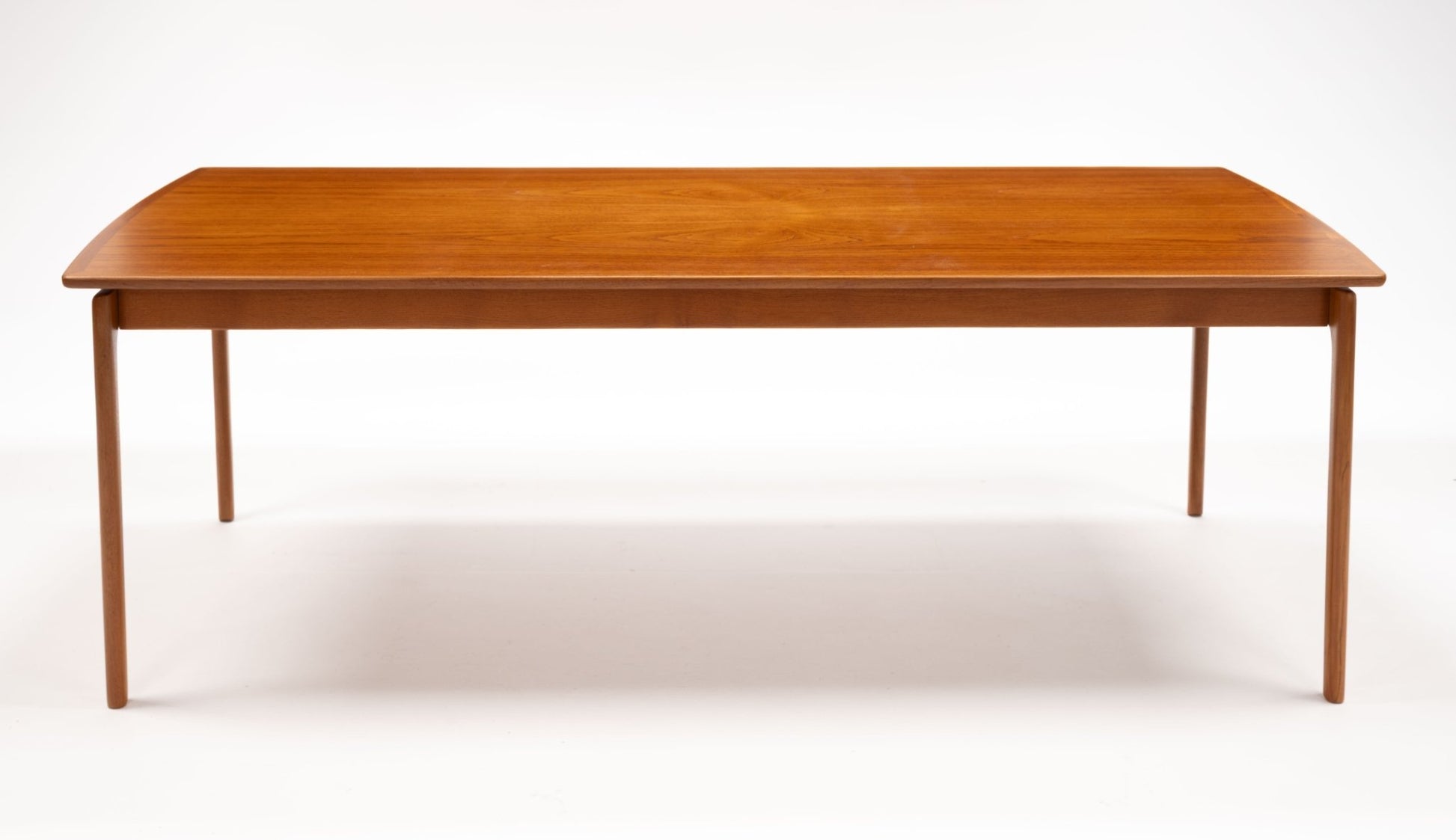 Mid-century modern teak floating top coffee table with slim legs and minimalist Danish design on white background