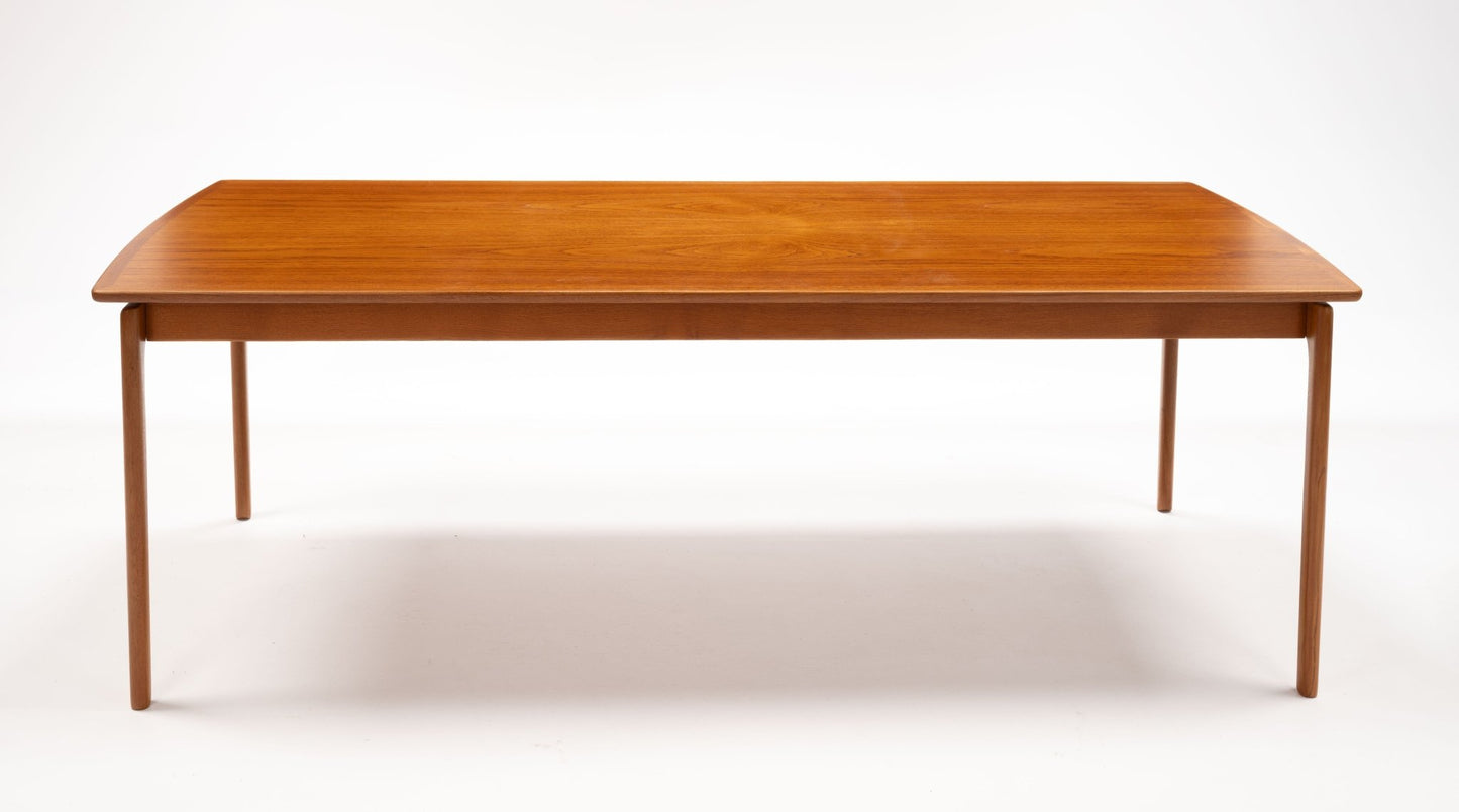 Mid-century modern teak coffee table by Ole Wanscher with slender legs and floating top design on white background.