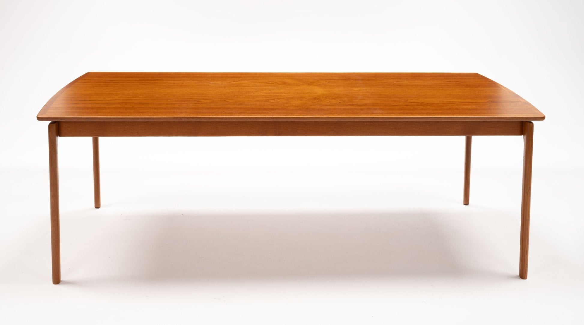 Mid-century modern teak coffee table by Ole Wanscher with slender legs and floating top design on white background.