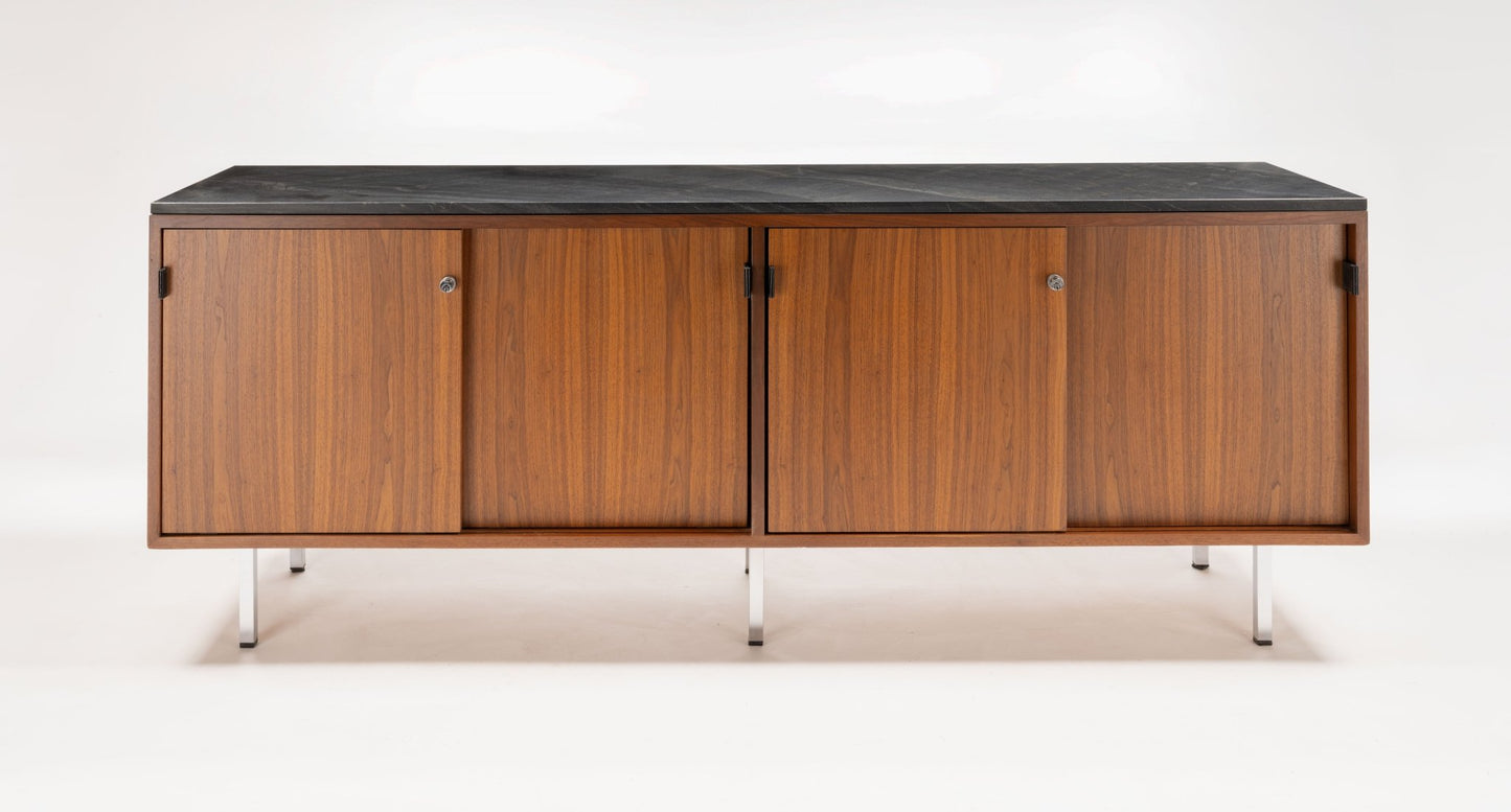 Mid-century walnut credenza with black marble top, four sliding doors with leather pulls, and polished metal legs.