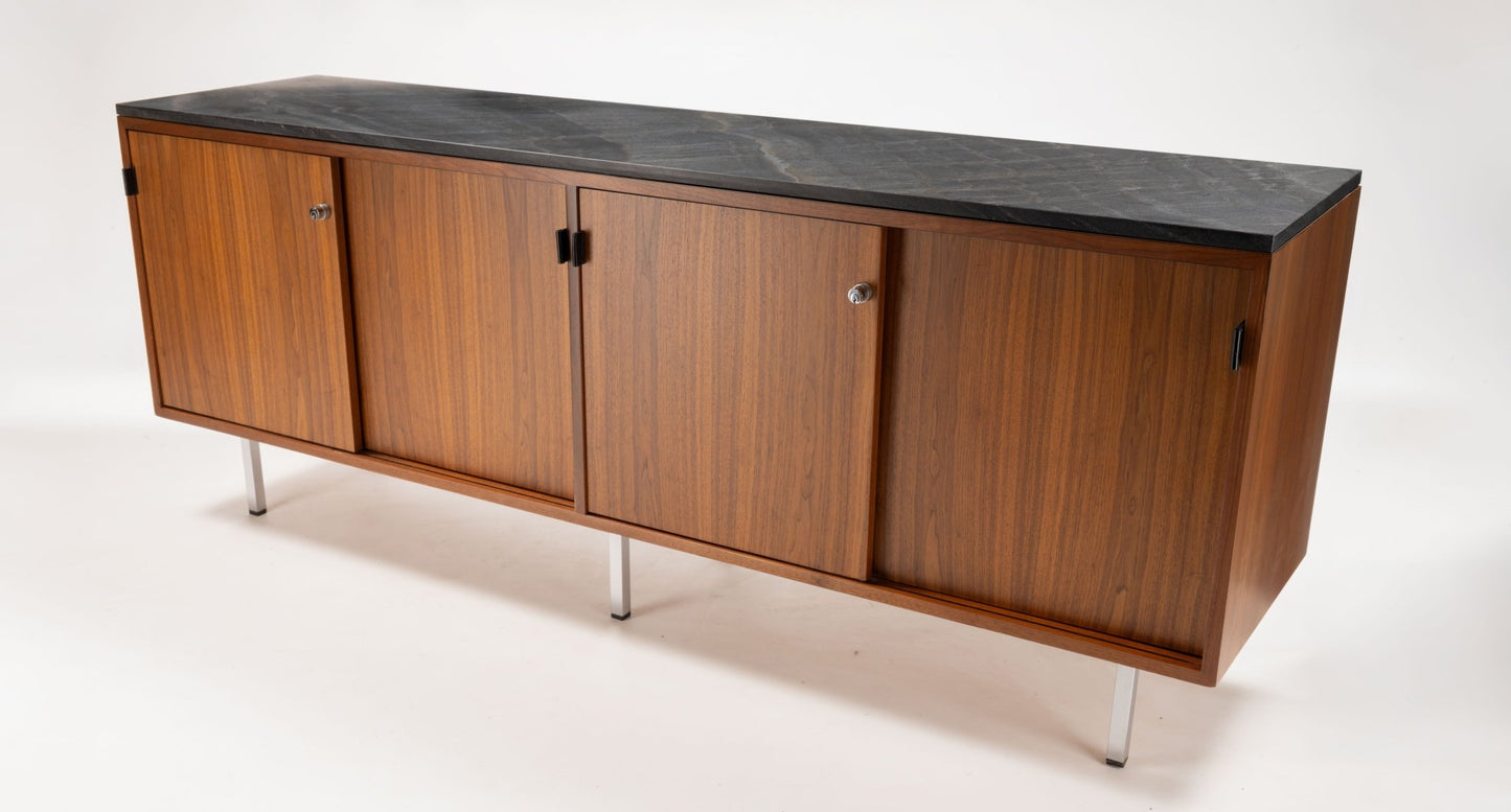 Mid-century Florence Knoll walnut credenza with black marble top, four sliding doors, and polished metal legs