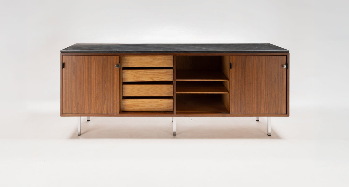 Mid-century walnut credenza with black marble top, sliding doors, leather pulls, and polished chrome legs
