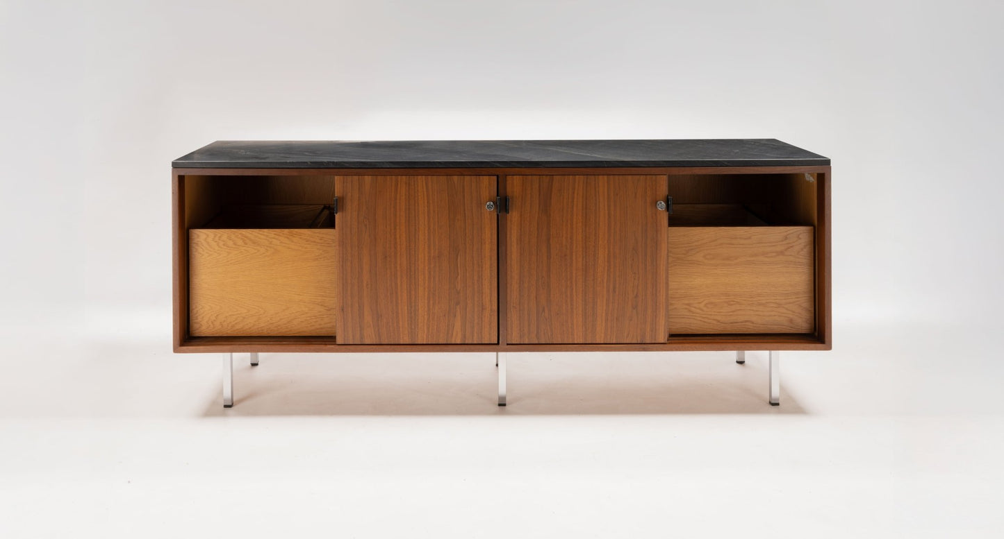 Mid-century walnut credenza with black marble top, four sliding doors with leather pulls, and polished metal legs.