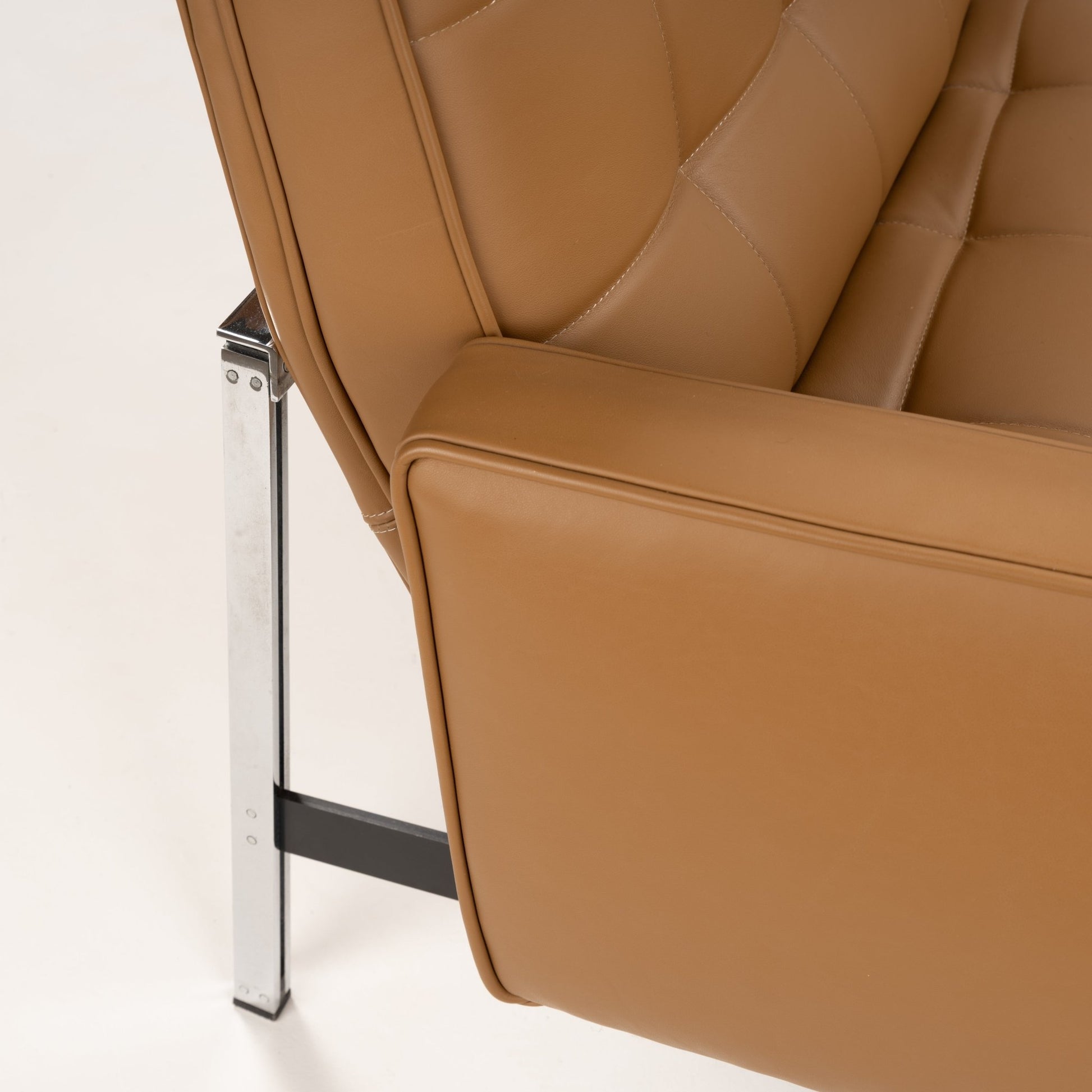 Florence Knoll 'Relaxed' Settee in Leather close view of caramel brown stitched upholstery broad arm and polished metal frame in mid century modern furniture style