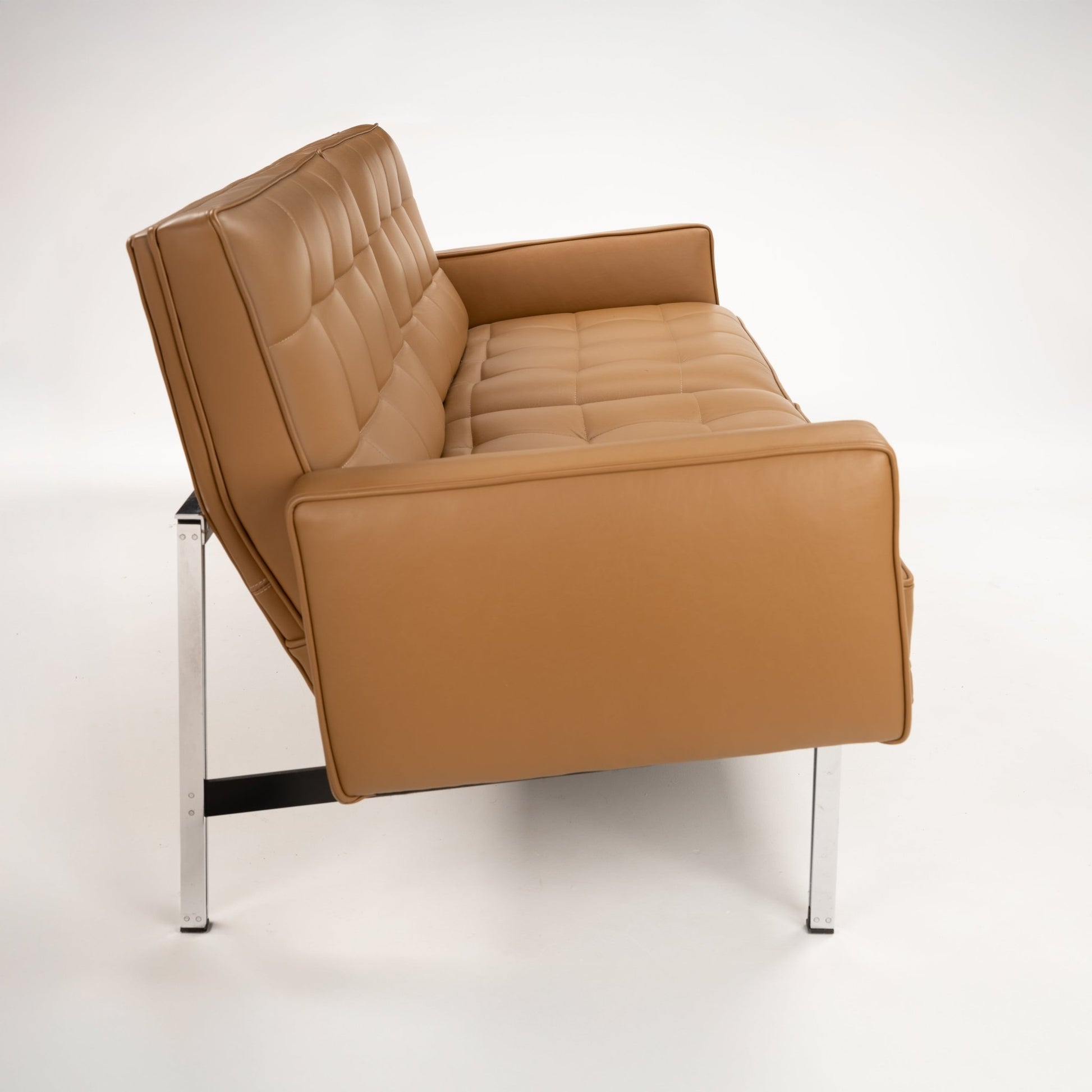 Florence Knoll 'Relaxed' Settee in Leather in caramel brown with tufted cushions broad arms and polished metal legs in mid century modern furniture style