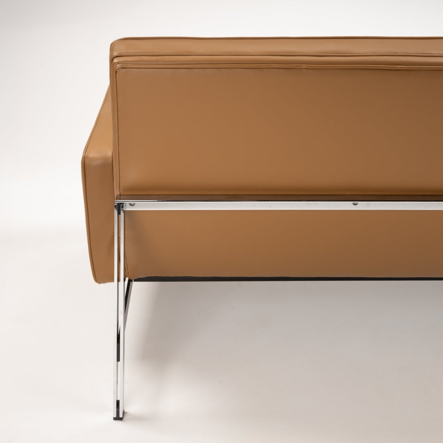 Florence Knoll 'Relaxed' Settee in Leather viewed from the rear in caramel brown with chrome frame and slender leg, showcasing mid century modern furniture design