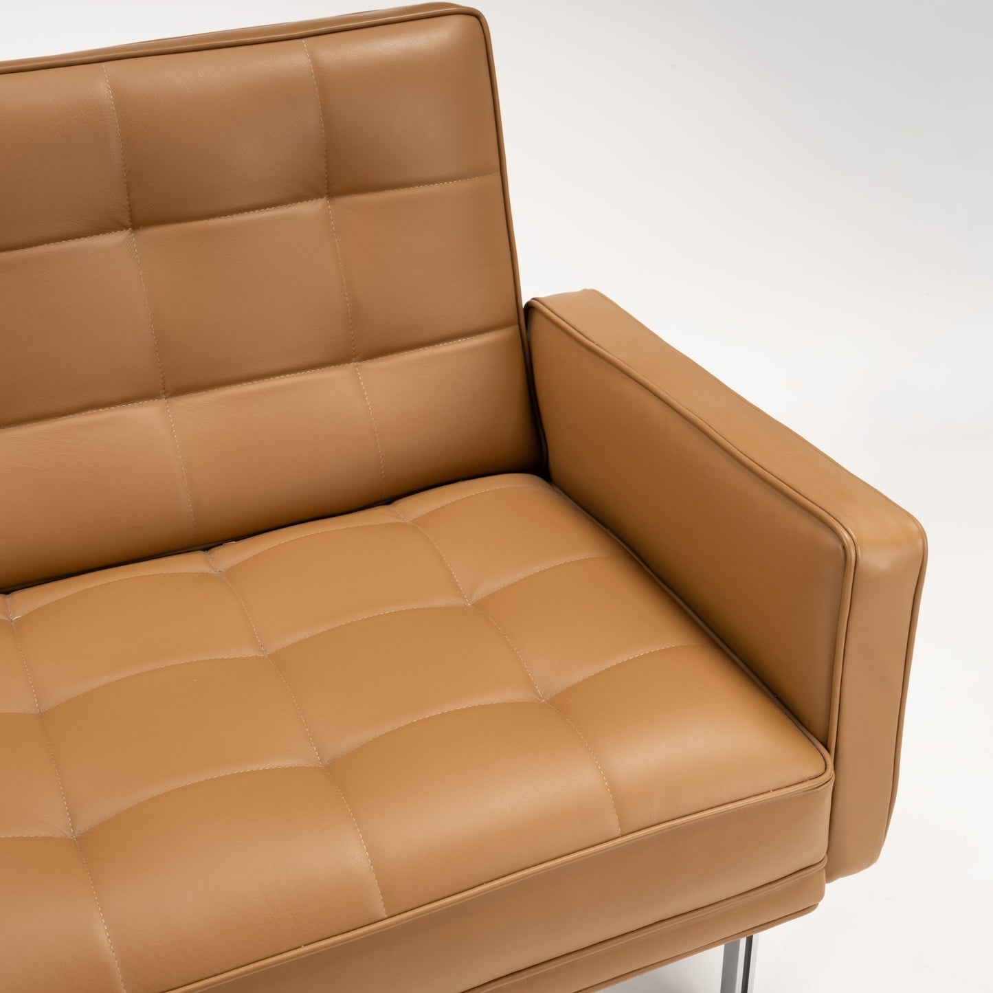 Florence Knoll 'Relaxed' Settee in Leather close view of caramel brown tufted cushions broad arm and polished frame in mid century modern furniture style