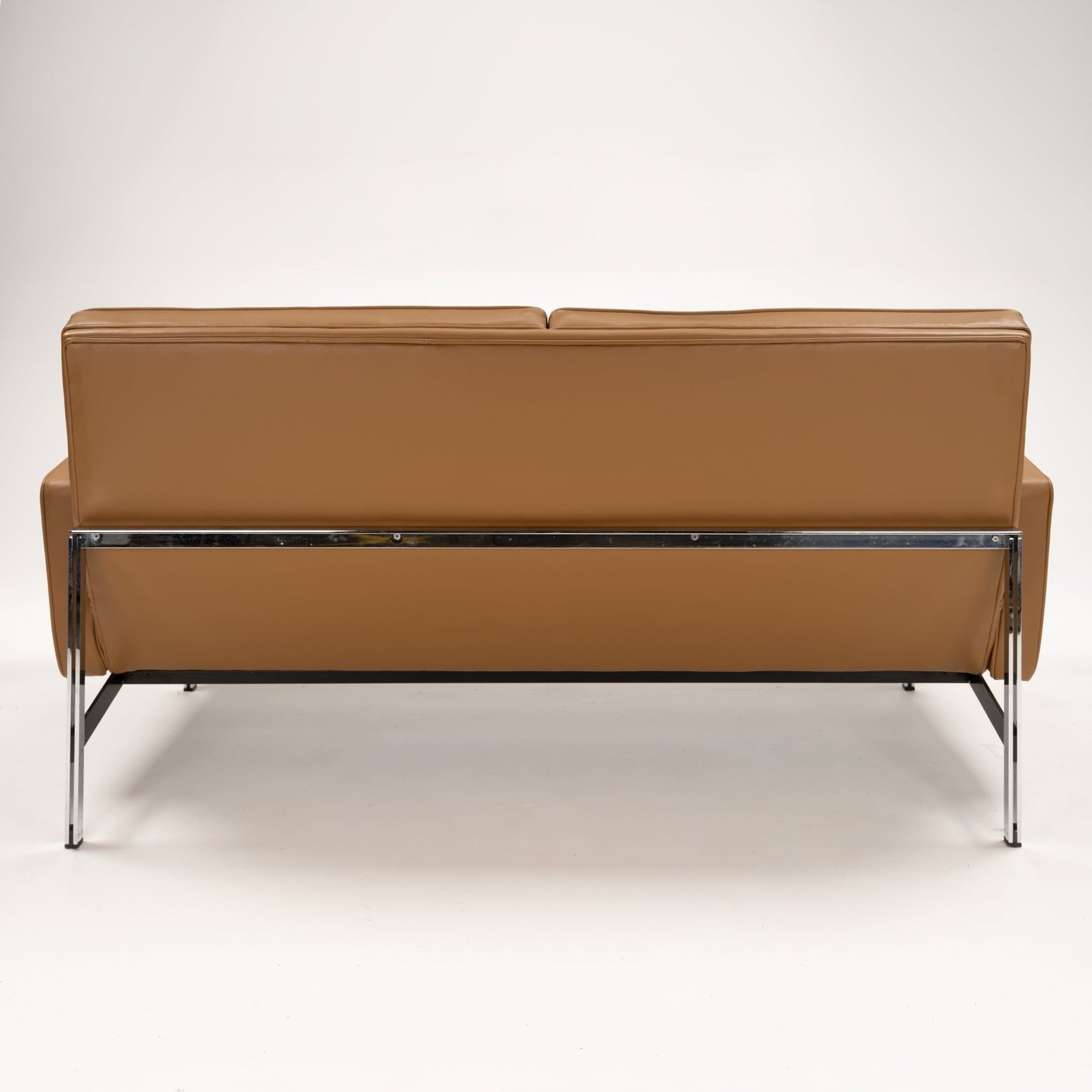 Florence Knoll 'Relaxed' Settee in Leather viewed from behind in caramel brown with chrome frame and slim legs in mid century modern furniture style