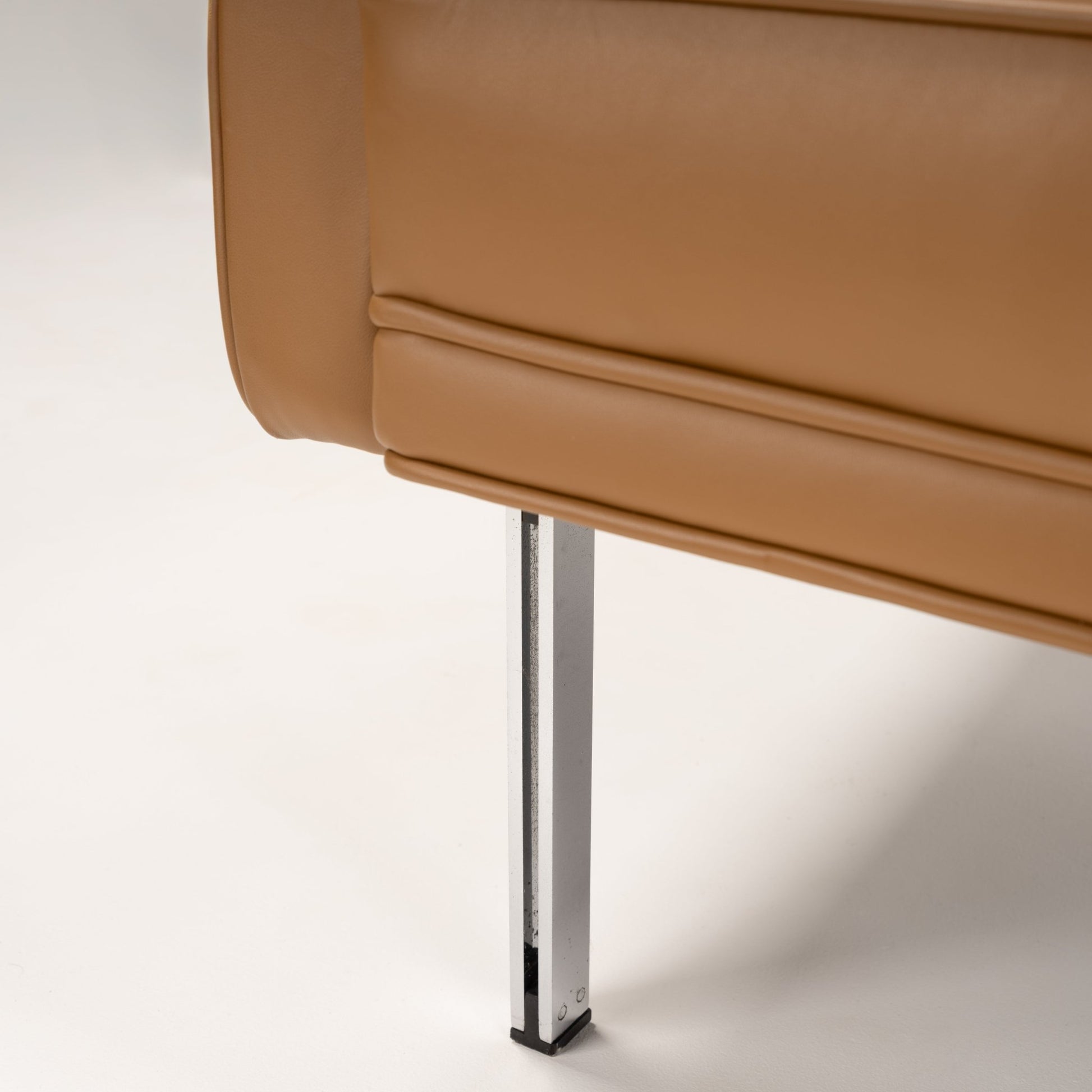 Florence Knoll 'Relaxed' Settee in Leather close up showing caramel brown upholstery and polished chrome leg in mid century modern furniture style