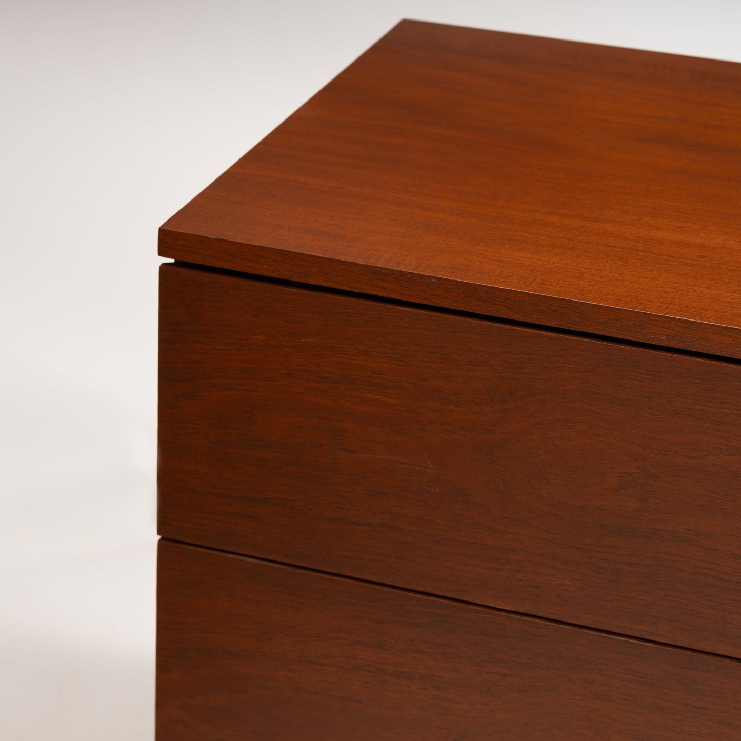 Florence Knoll Walnut Chest of Drawers close view showing warm walnut grain aligned drawer fronts and an overhanging top in mid century modern furniture style