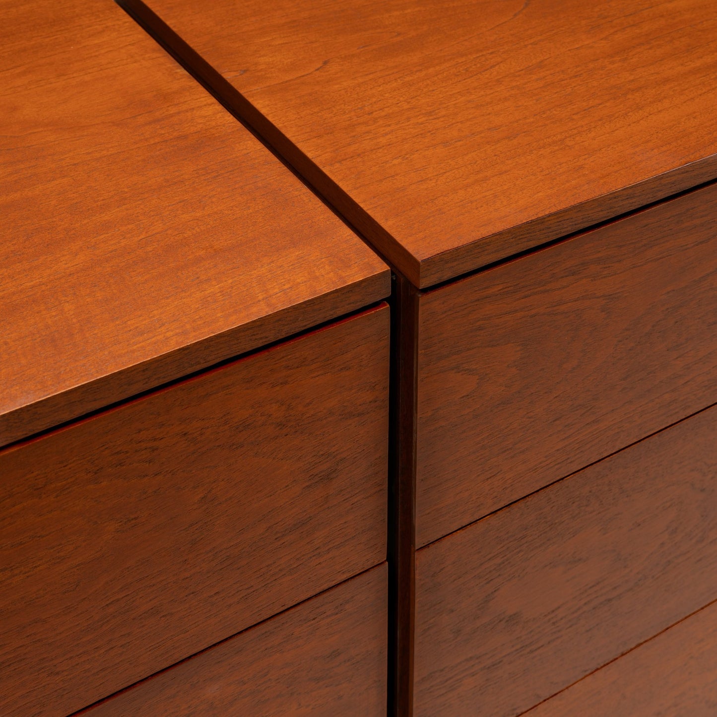 Florence Knoll Walnut Chest of Drawers close detail showing warm walnut grain aligned drawer fronts and seamless corner joinery in mid century modern furniture style