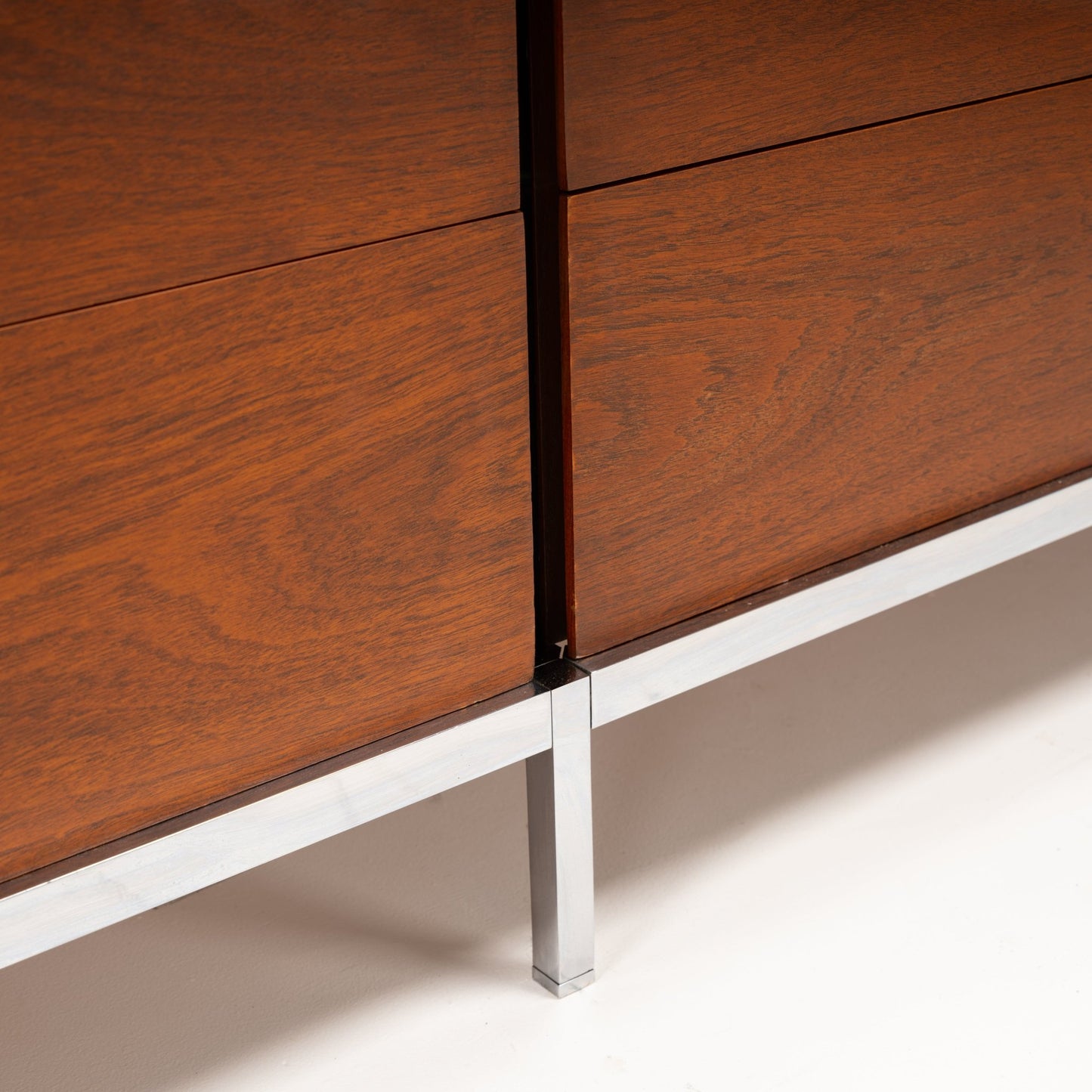 Florence Knoll Walnut Chest of Drawers close detail showing warm walnut panels crisp joinery and a polished metal leg in mid century modern furniture style