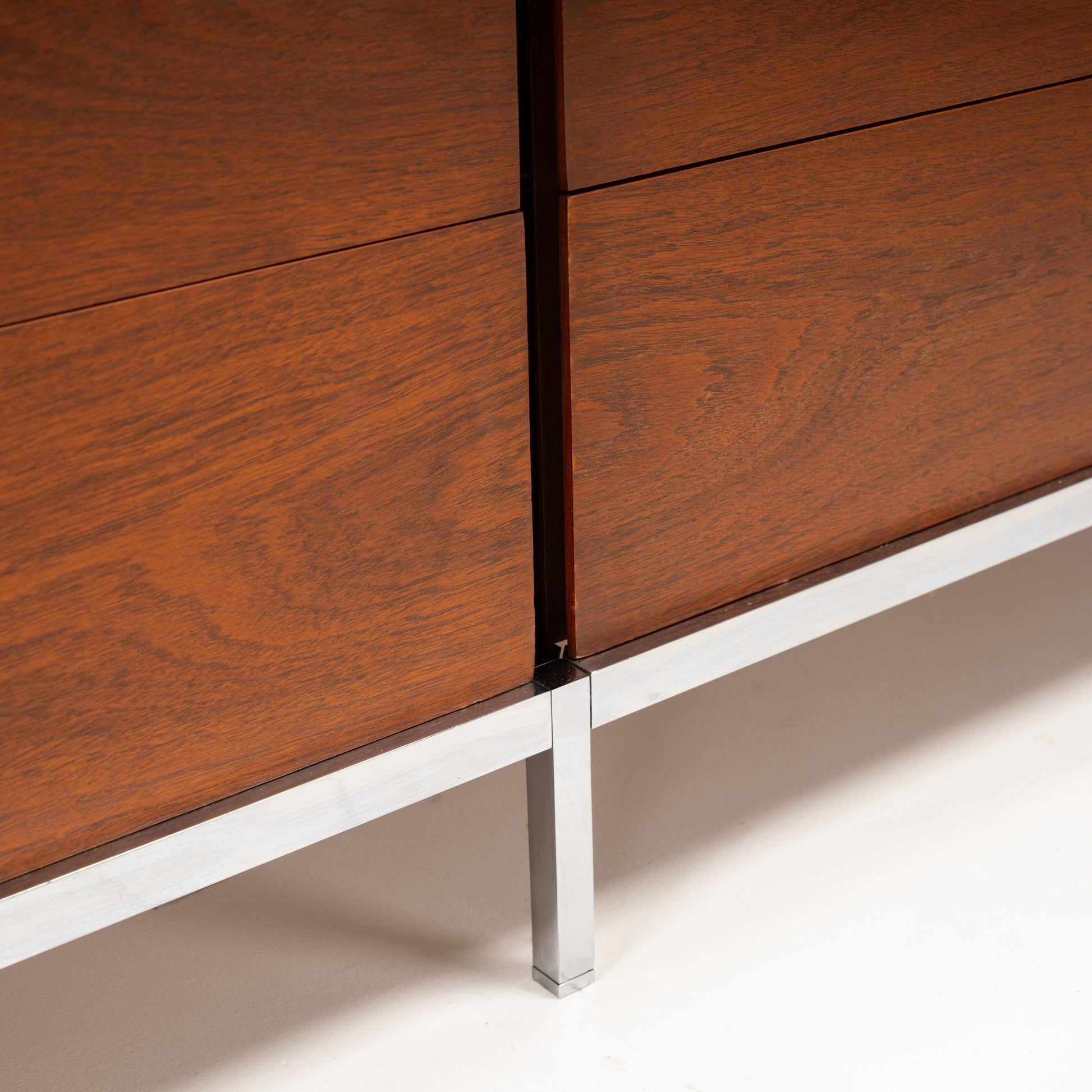 Florence Knoll Walnut Chest of Drawers close detail showing warm walnut panels crisp joinery and a polished metal leg in mid century modern furniture style