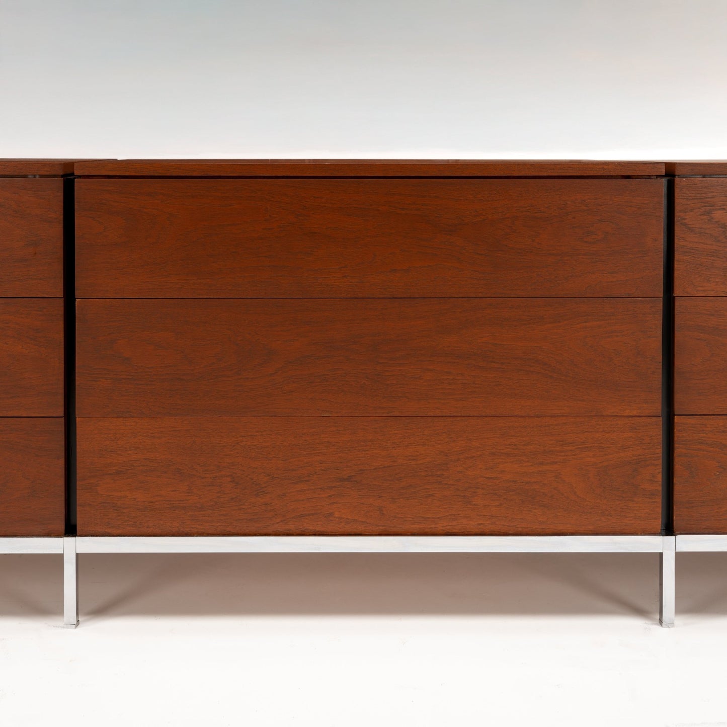 Florence Knoll Walnut Chest of Drawers showing rich walnut grain clean panel fronts and slender metal legs in mid century modern furniture style