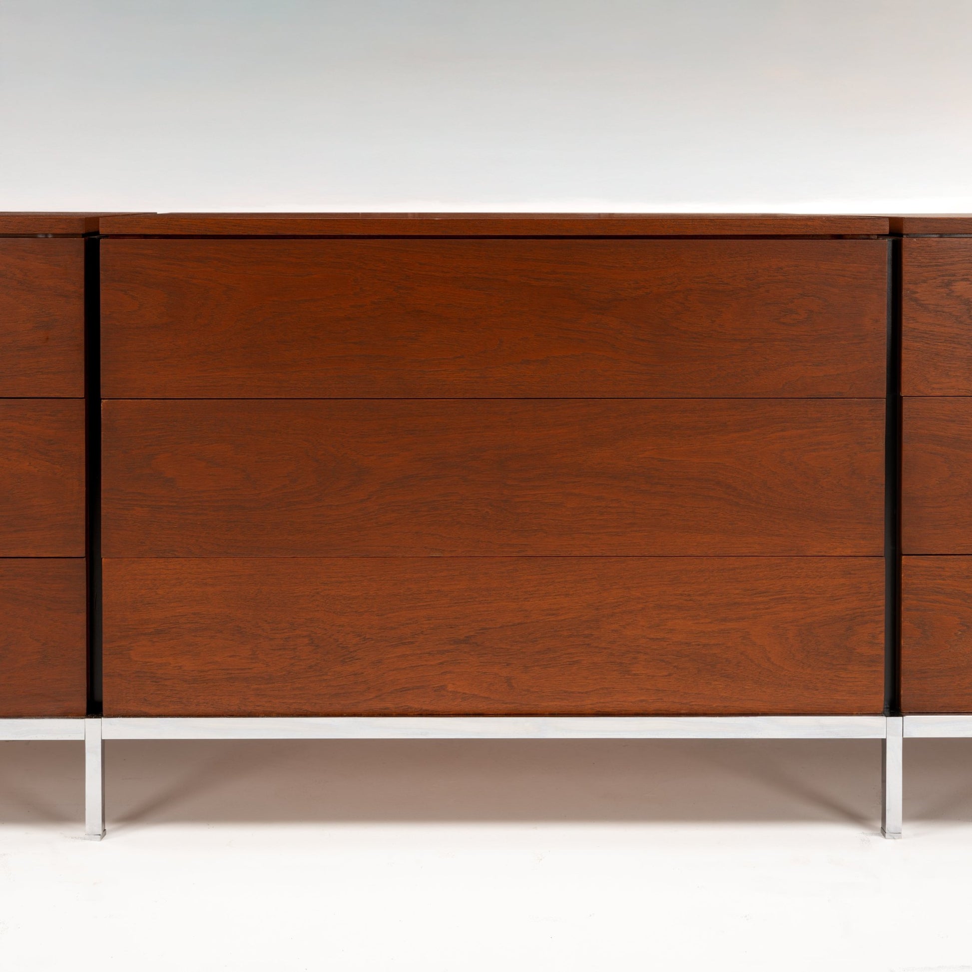 Florence Knoll Walnut Chest of Drawers showing rich walnut grain clean panel fronts and slender metal legs in mid century modern furniture style