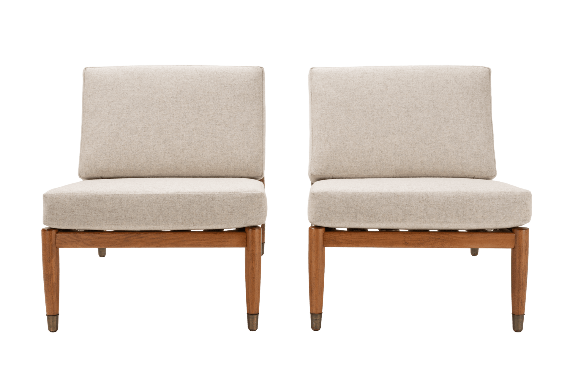 Pair of Folke Ohlsson armless slipper lounge chairs with beige upholstery and beechwood frames on white background