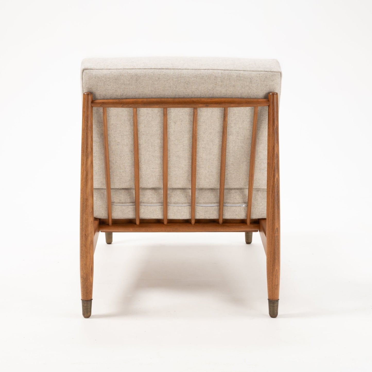 Rear view of Folke Ohlsson slipper lounge chair showing beechwood frame with vertical slats and beige upholstery